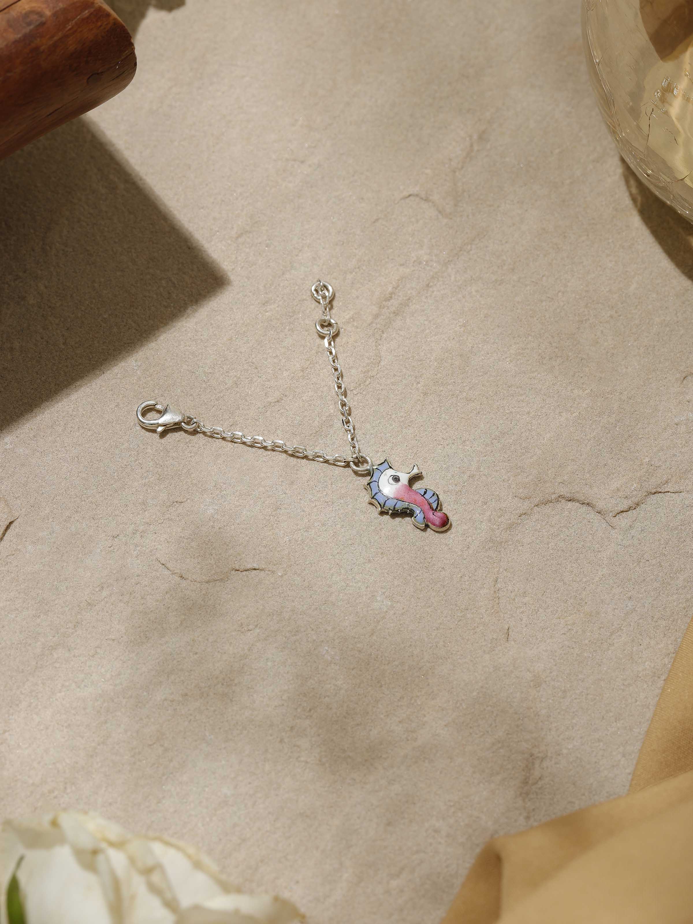 Angled side view highlighting intricate meenakari work on silver watch charm