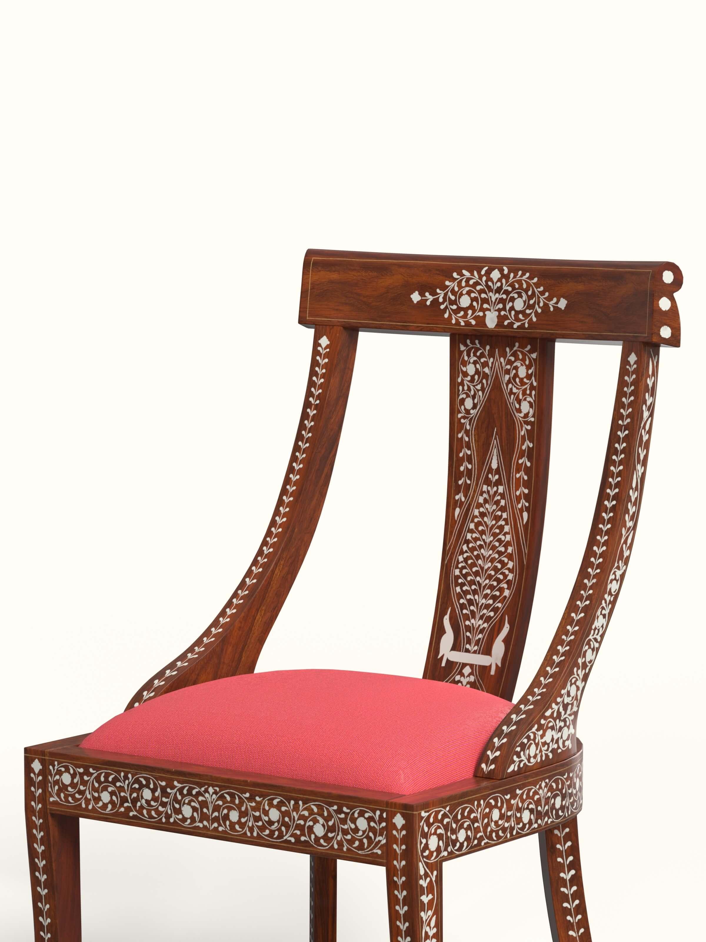 Close-up view of the bone inlay design on the red woven fabric sheesham wood dining chair, emphasizing the artistic details