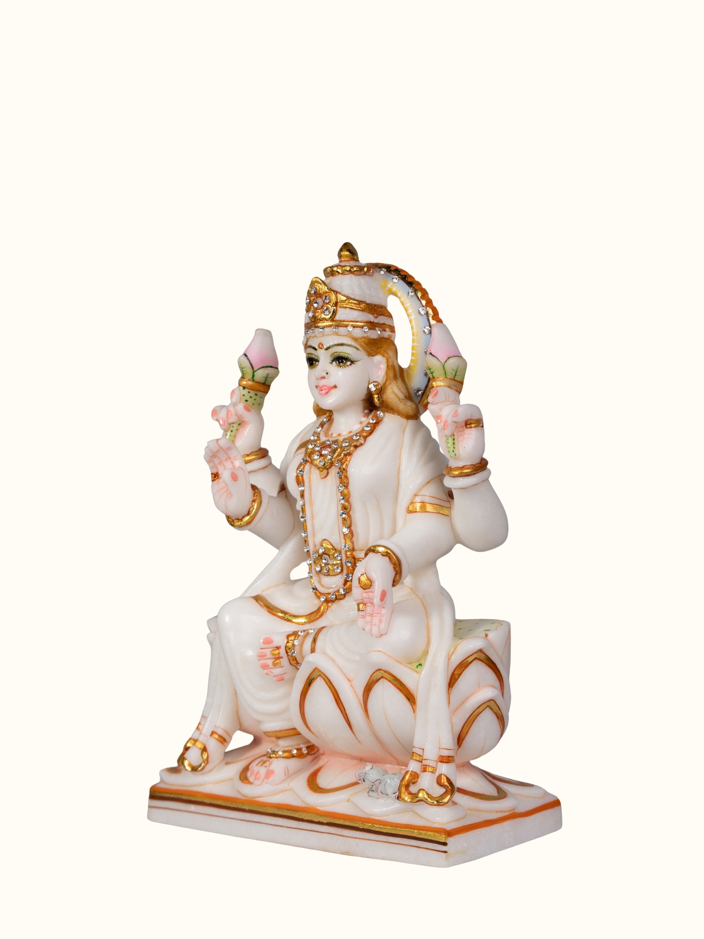 Angled view of carved marble Lakshmi idol showing fine carving details