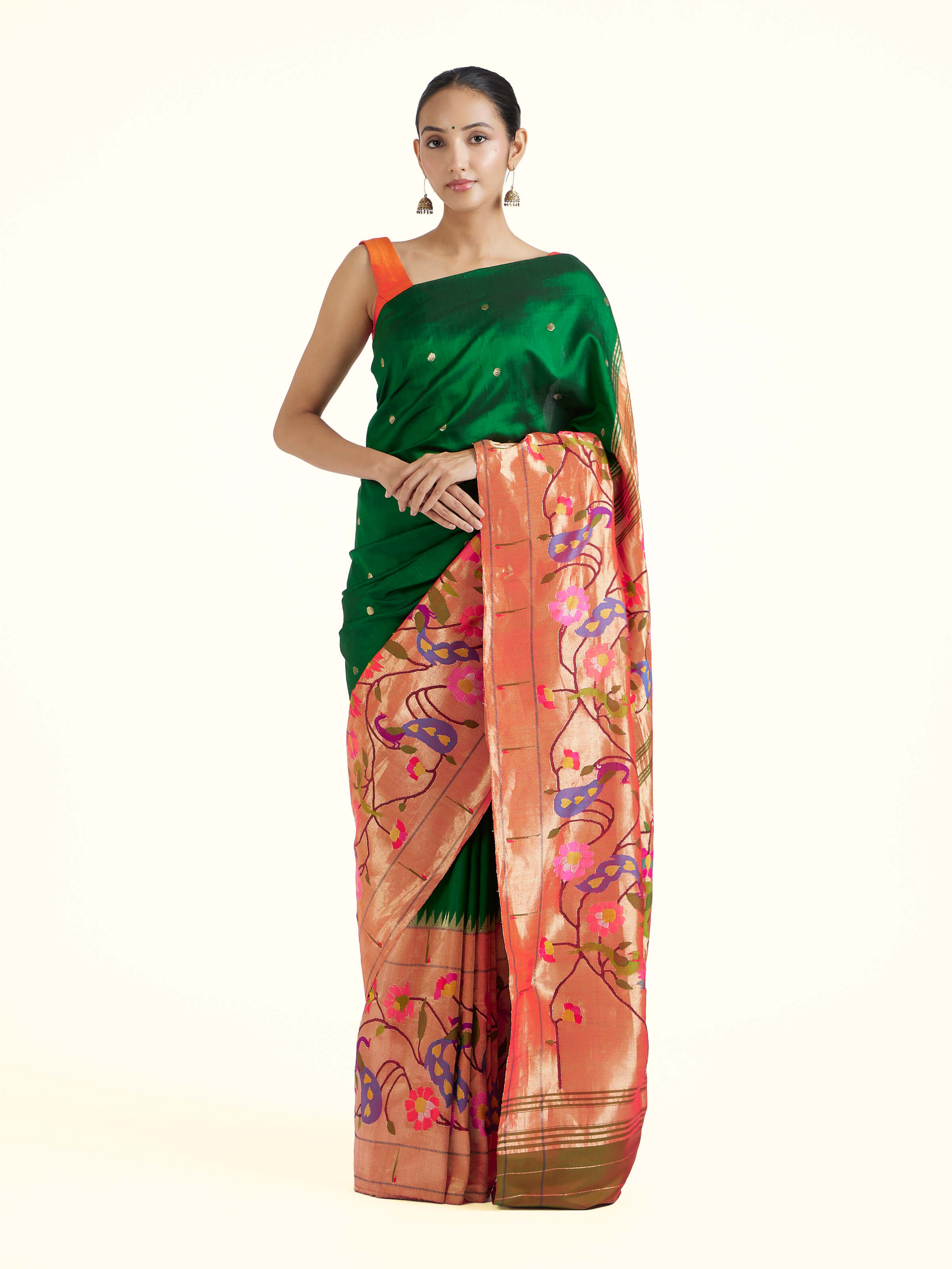 Front view of green silk Paithani saree showcasing vibrant hue and traditional motifs