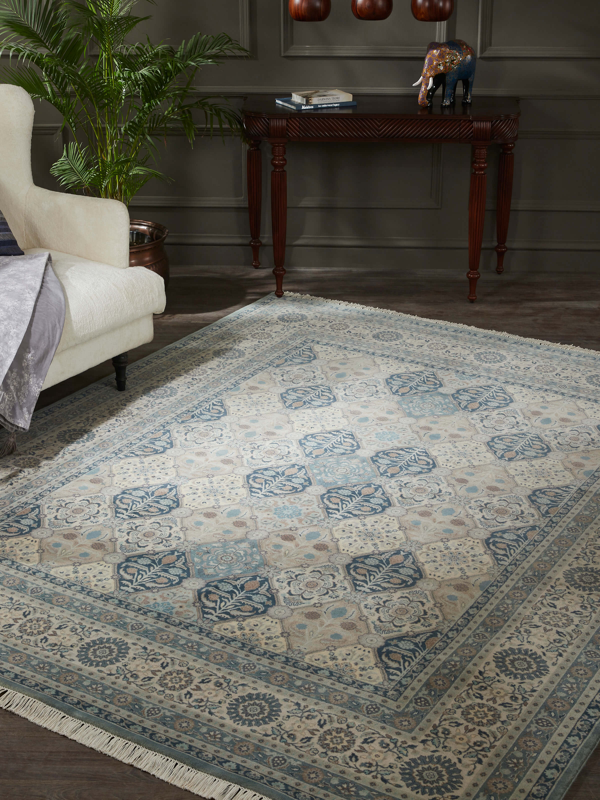Lifestyle shot of blue-grey Sarouk rug showcasing floral motifs and rich wool texture in a room setting