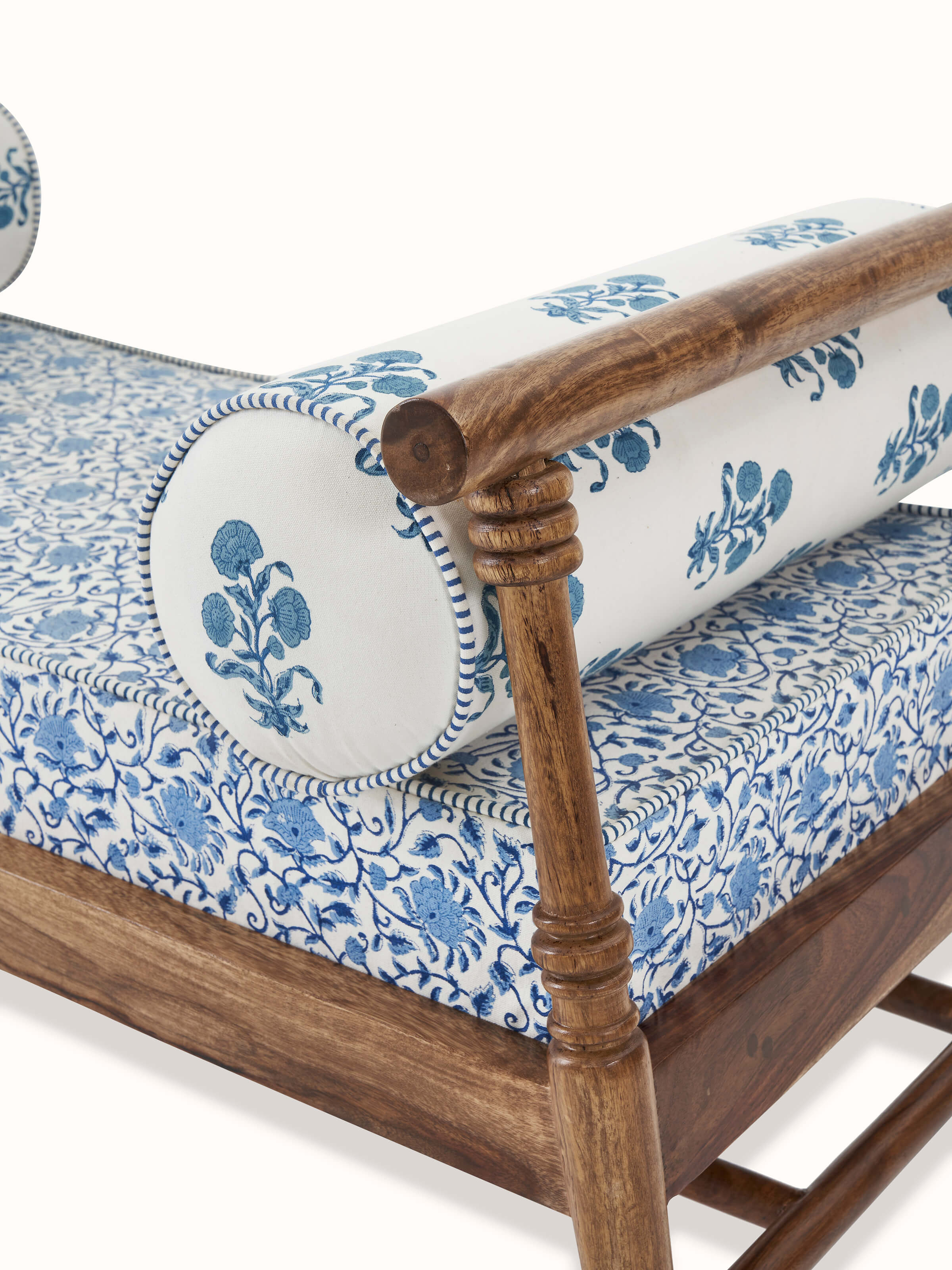 Close-up of the slanted legs and Sanganeri block print on the Sheesham wood bench
