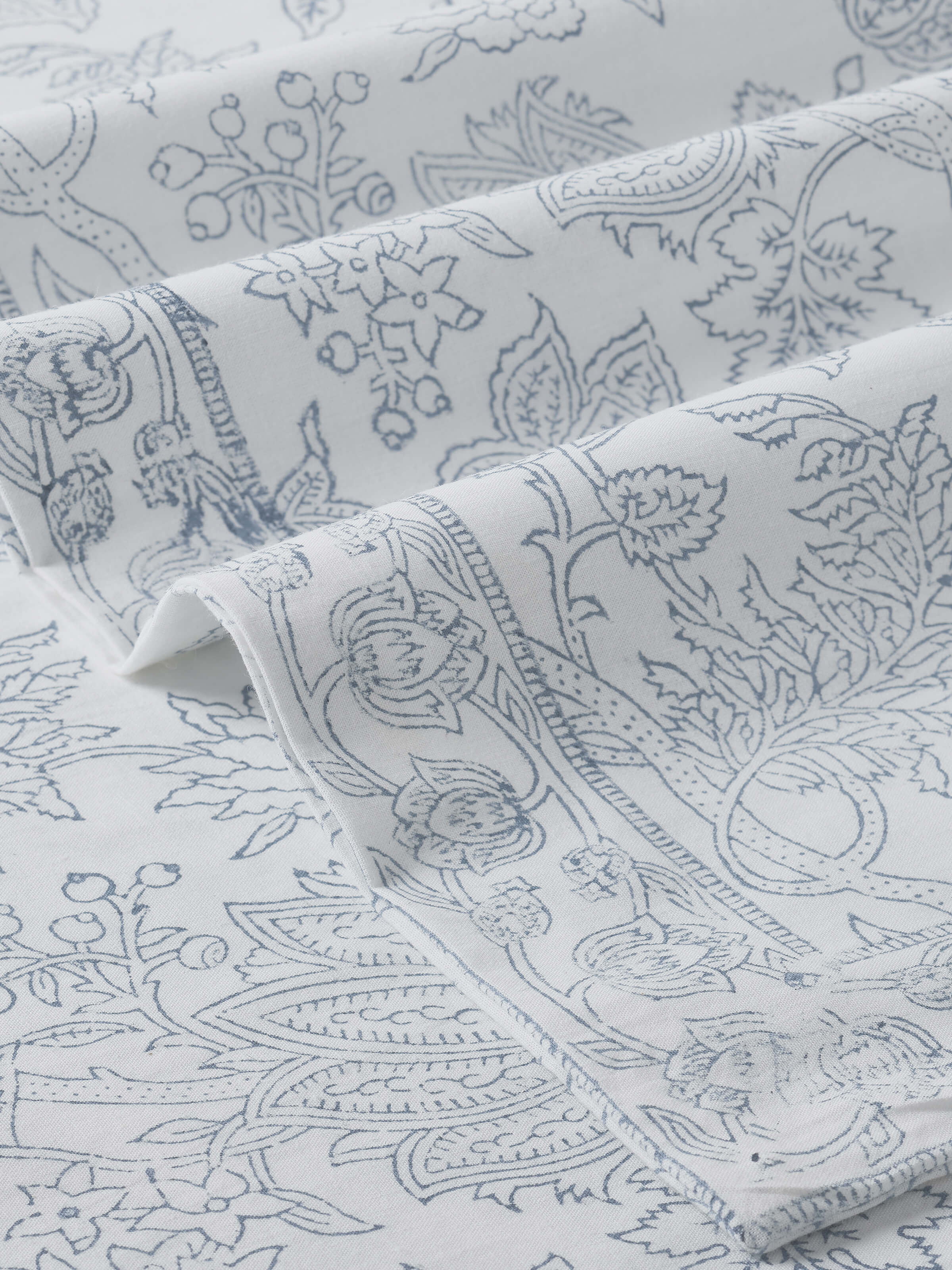 Close-up detail of fabric texture and hand block printed pattern.