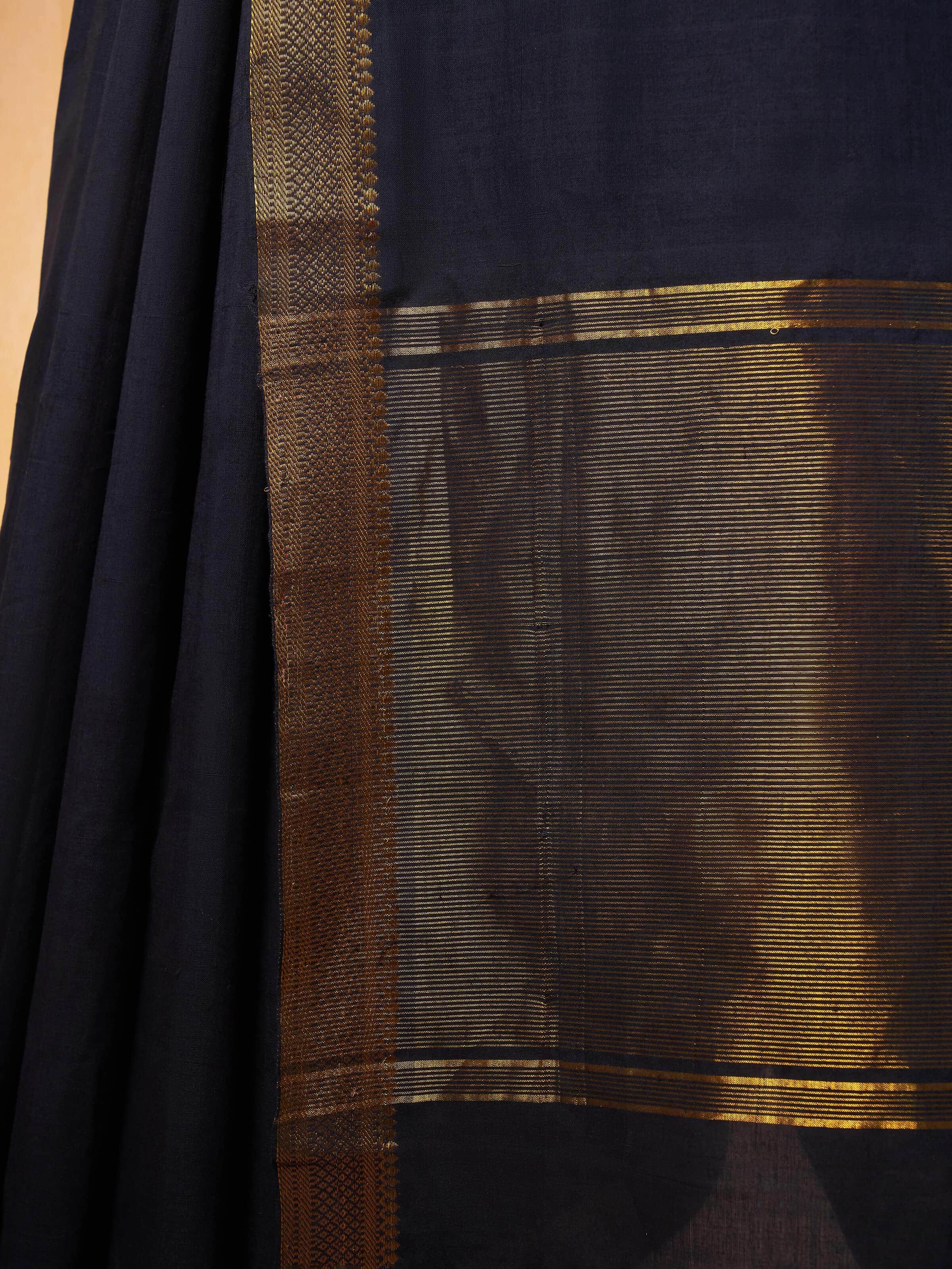 Angle view of Black cotton Mangalgiri saree showing fabric and design details