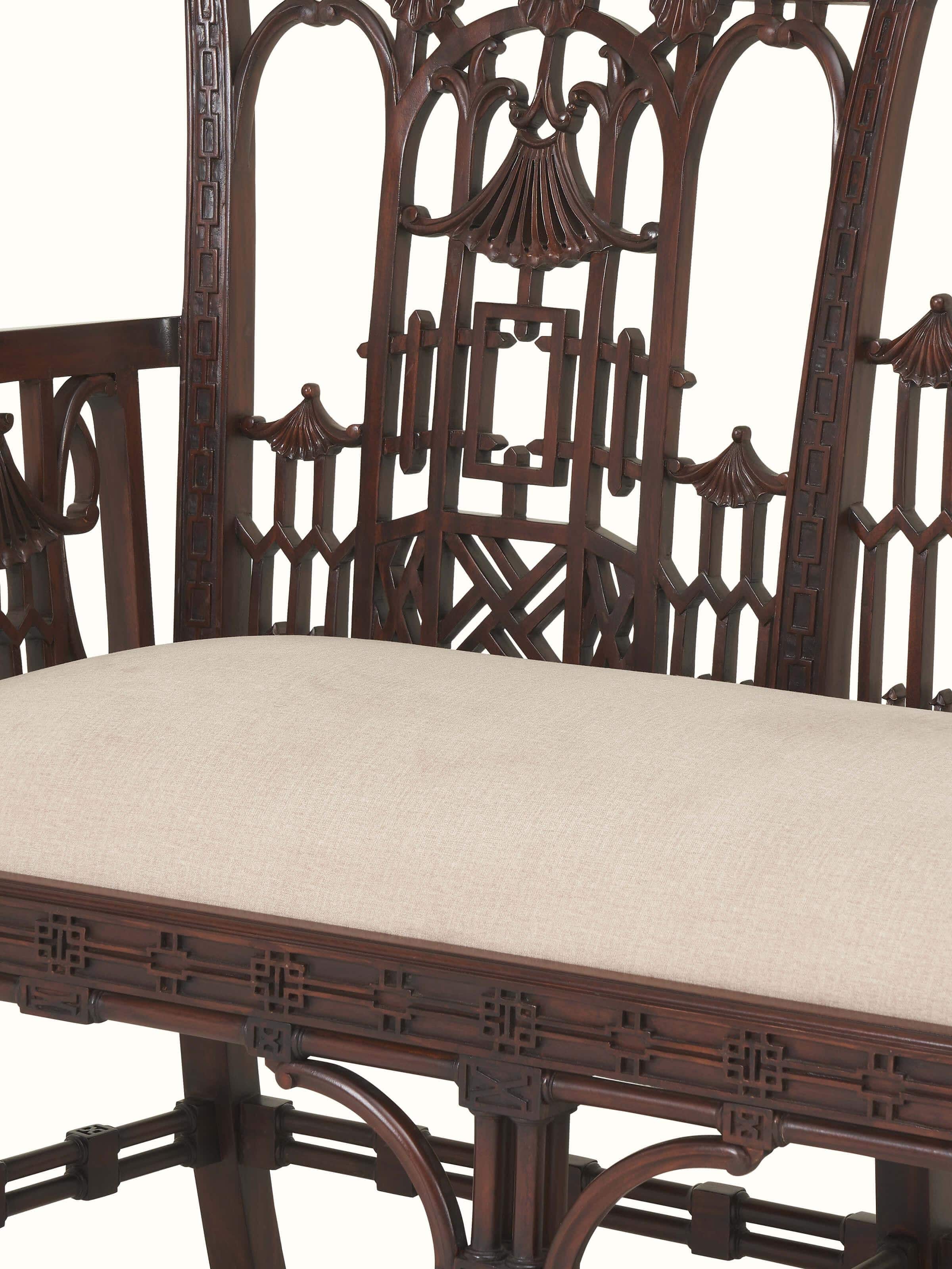 Detail shot of upholstered mahogany wood sofa showing close-up of seat cushions and wood grain