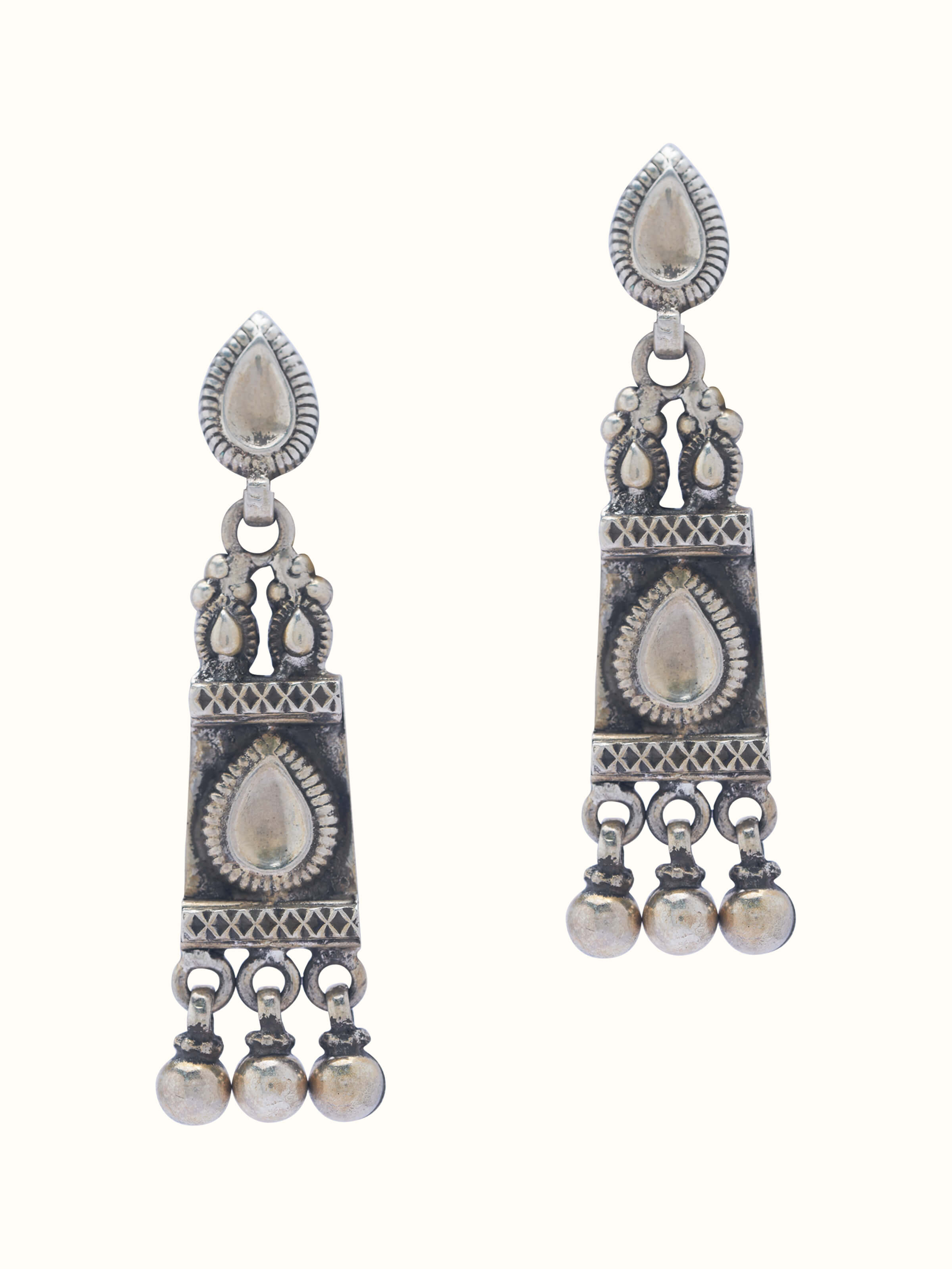 Front view of Smithing drop earrings showcasing detailed metalwork