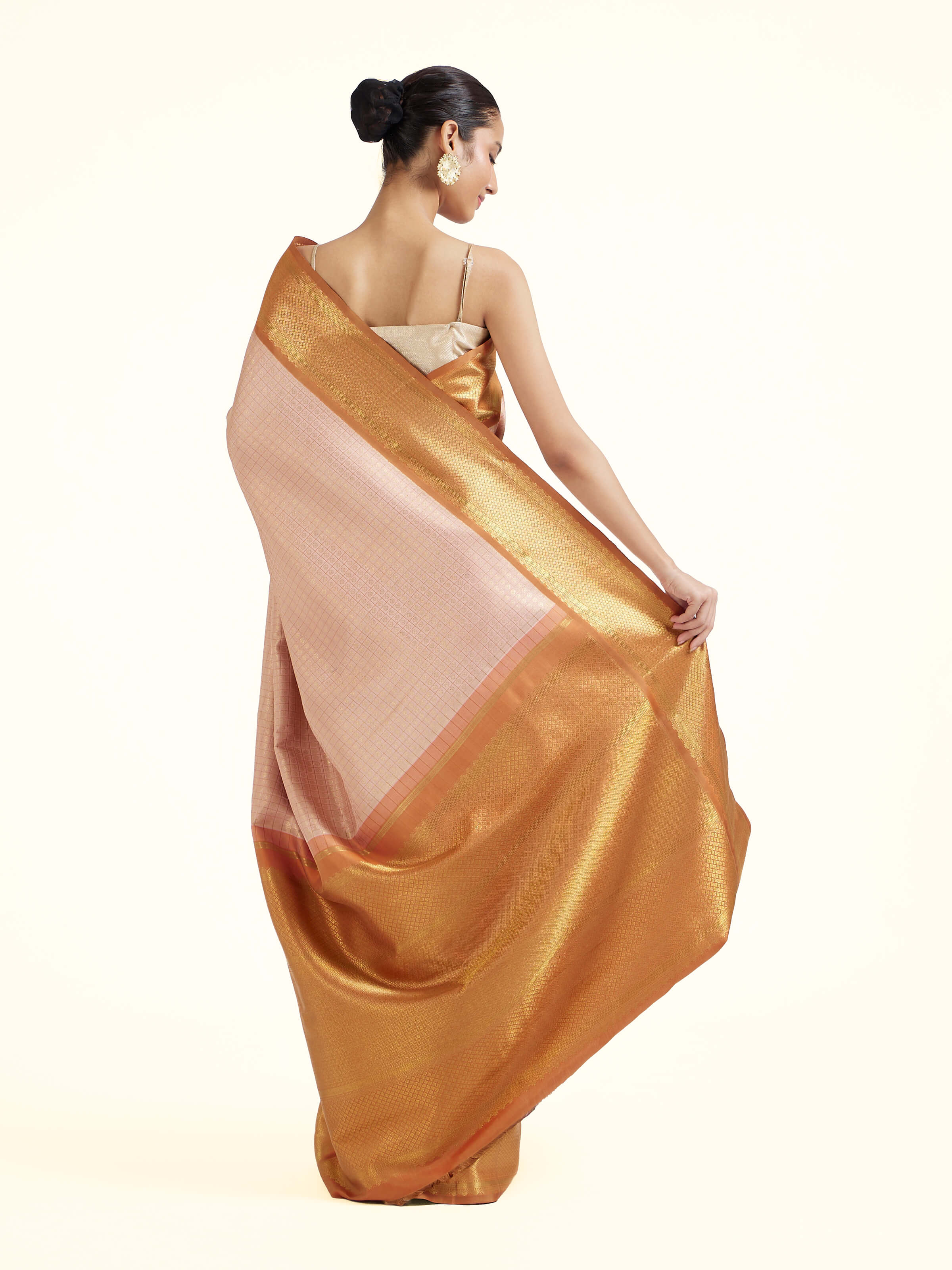 Back view of pink silk Kancheepuram saree displaying ornate pallu design