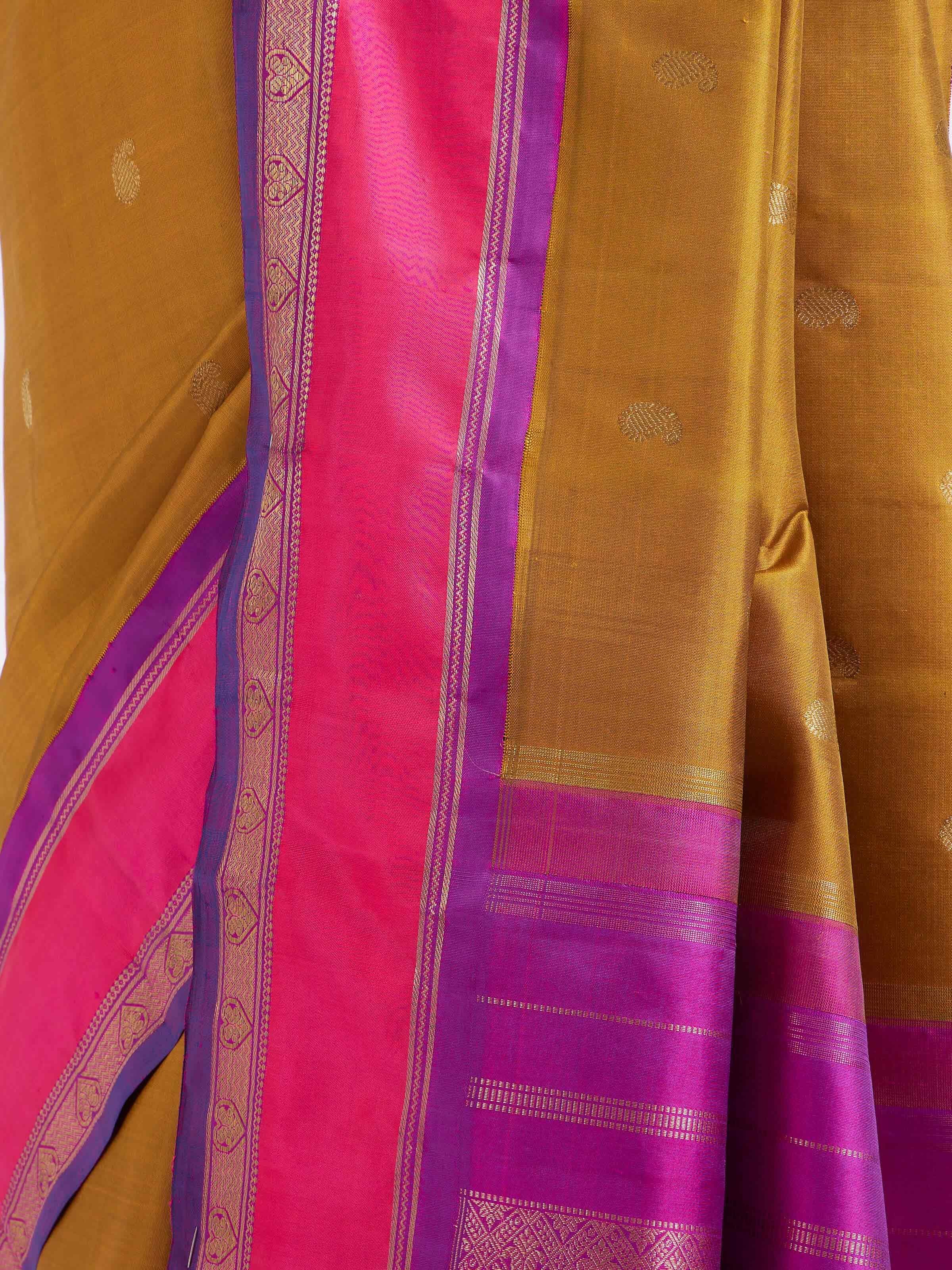 Detail view of olive silk Kancheepuram saree showing fine silk texture and zari craftsmanship