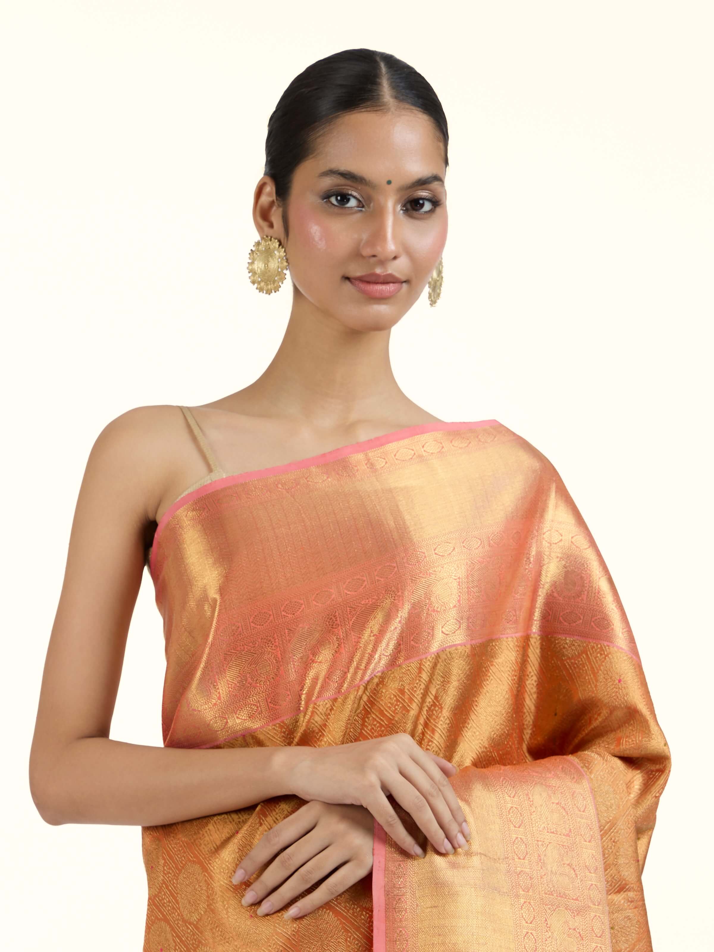 Angled view of yellow silk Kancheepuram saree highlighting traditional weave and sheen