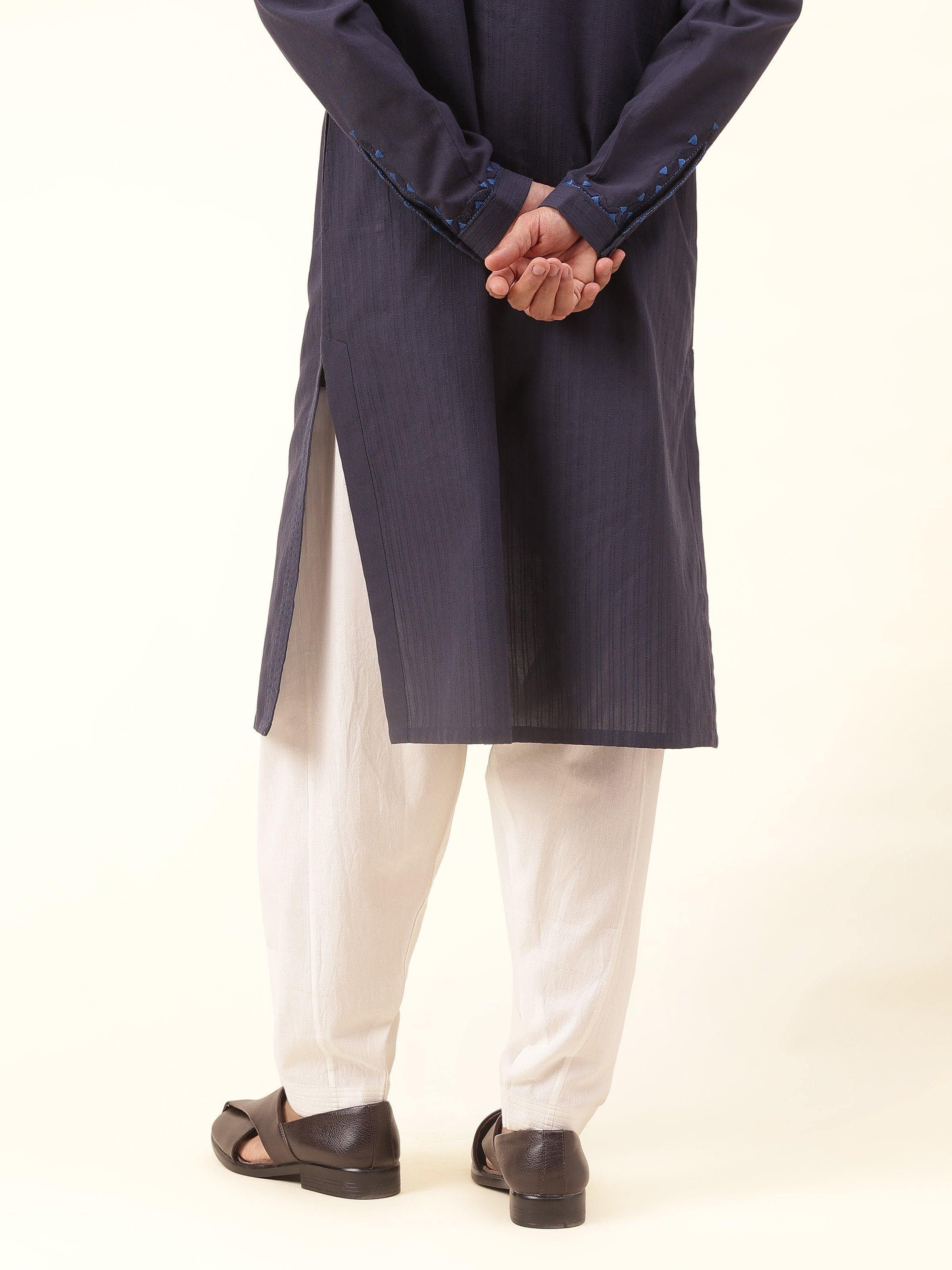 Back view of off-white cotton salwaar showcasing neat stitching and subtle gathers