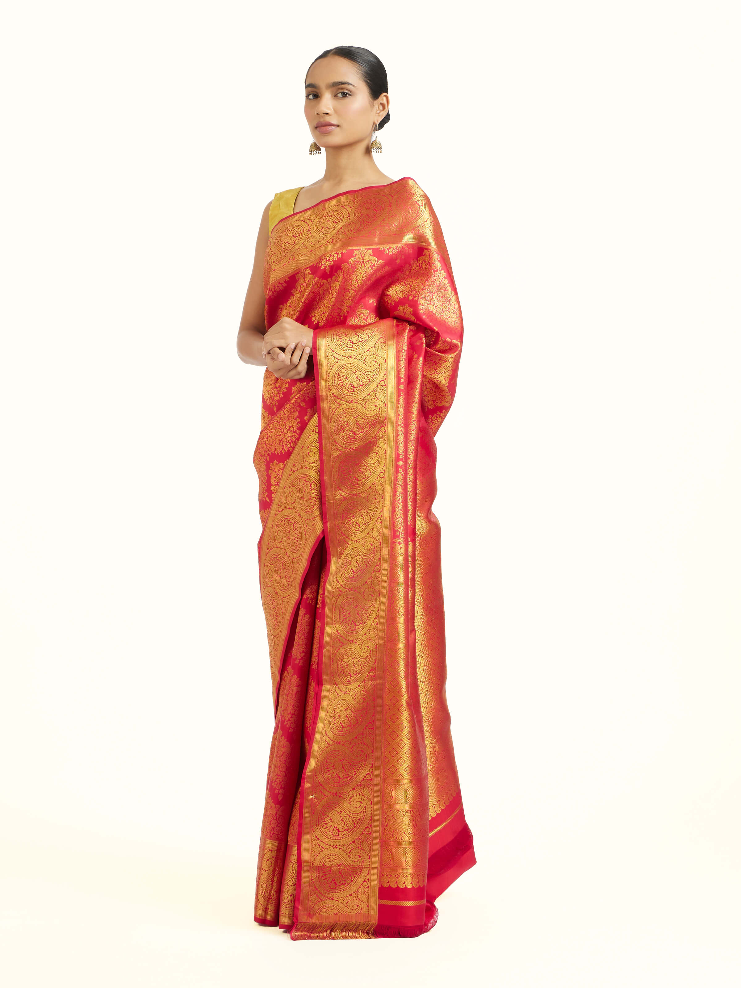 Side view of red silk Kancheepuram saree with graceful drape and contrast border