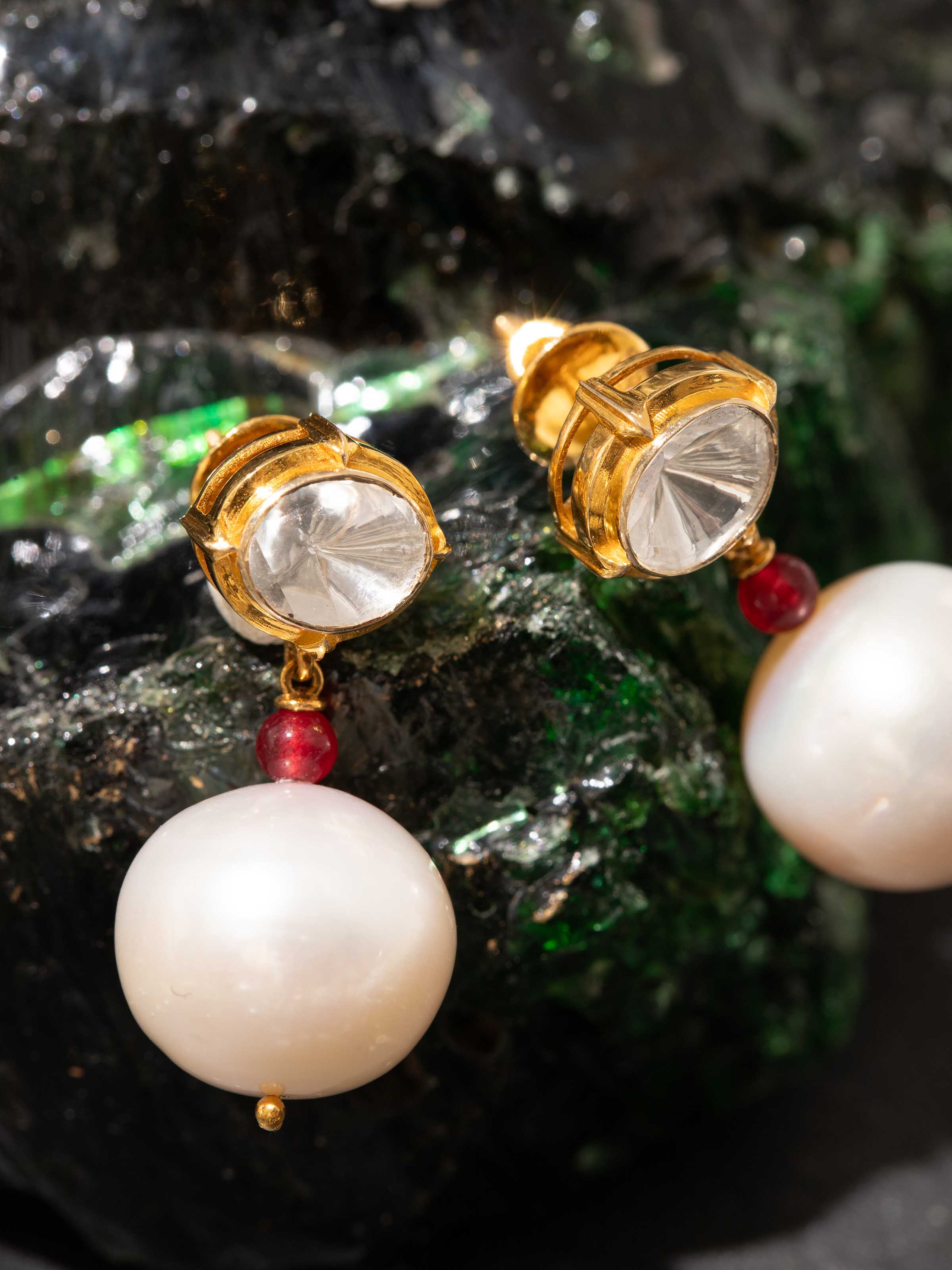 Overhead view of Dank Polki earrings emphasizing circular form and stone detailing