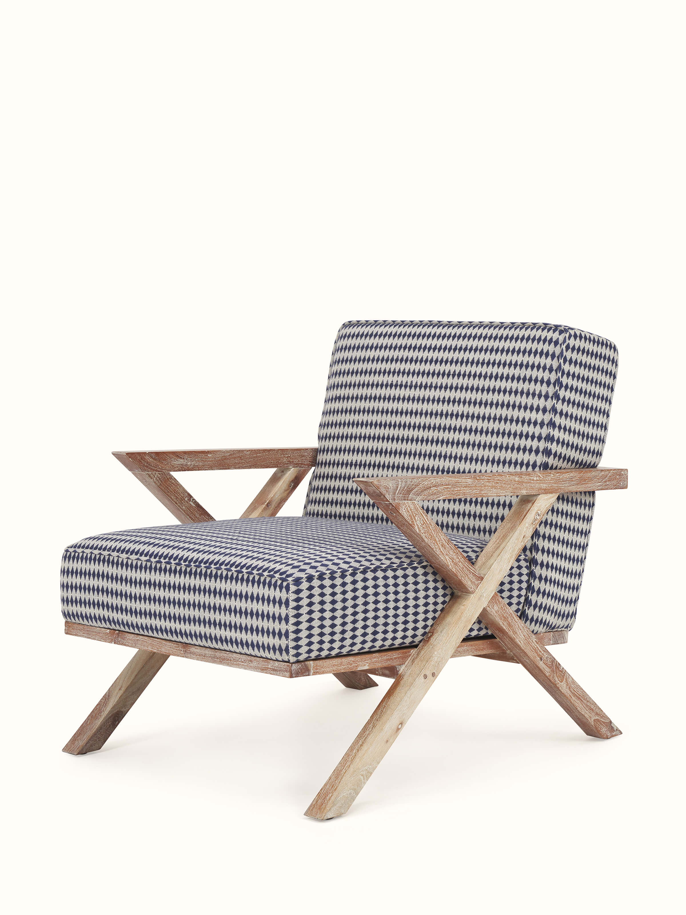 Angled view of Swadesh Upholstered Acacia Wood Armchair showing its cozy, padded seat and finely crafted wood structure