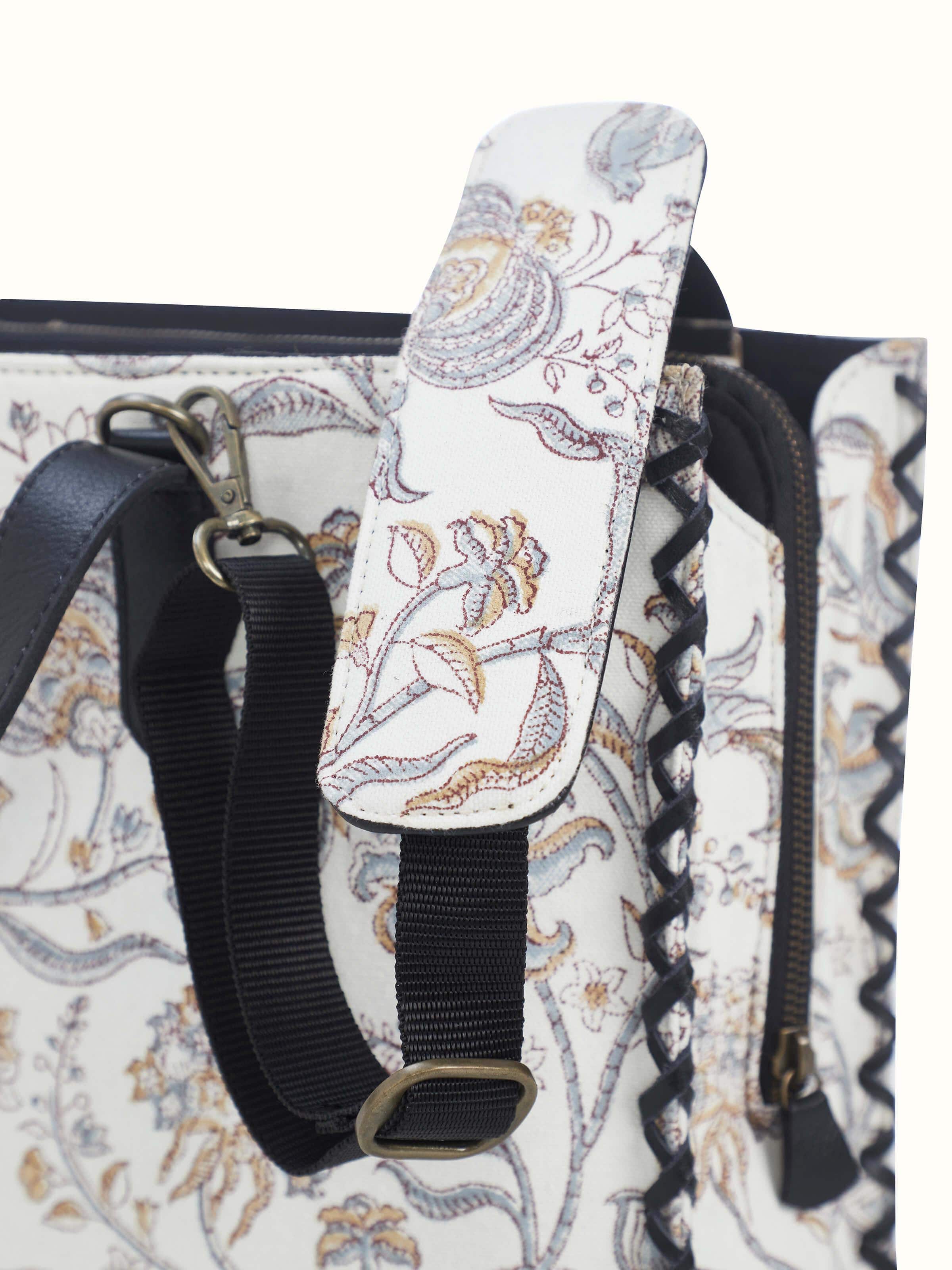 Black leather and textile hand block printed tote bag close-up showing stitching and material details