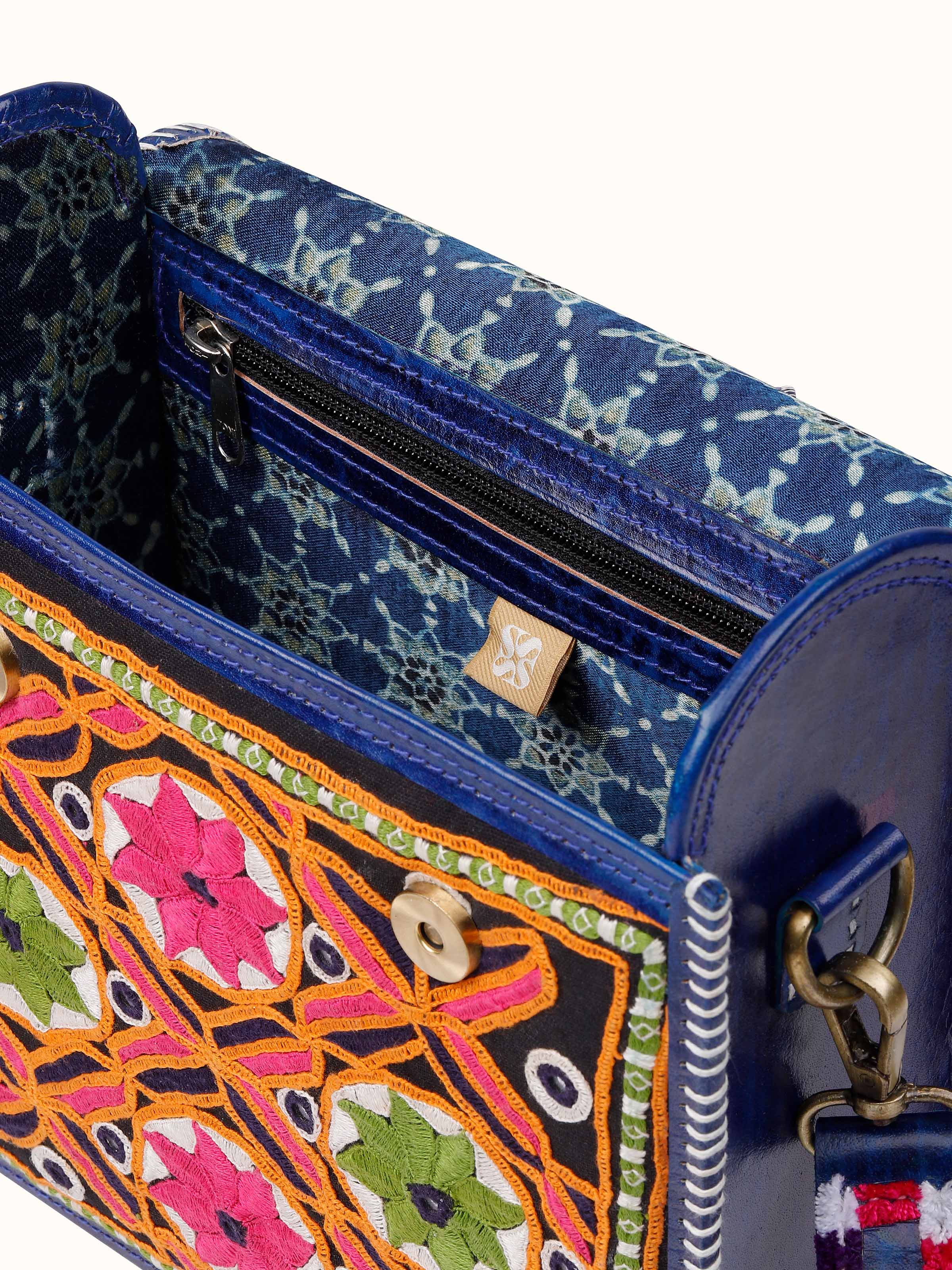 Close-up detail of Kutchi Leather Embroidered Messenger Bag focusing on leather texture and fine embroidery stitches.