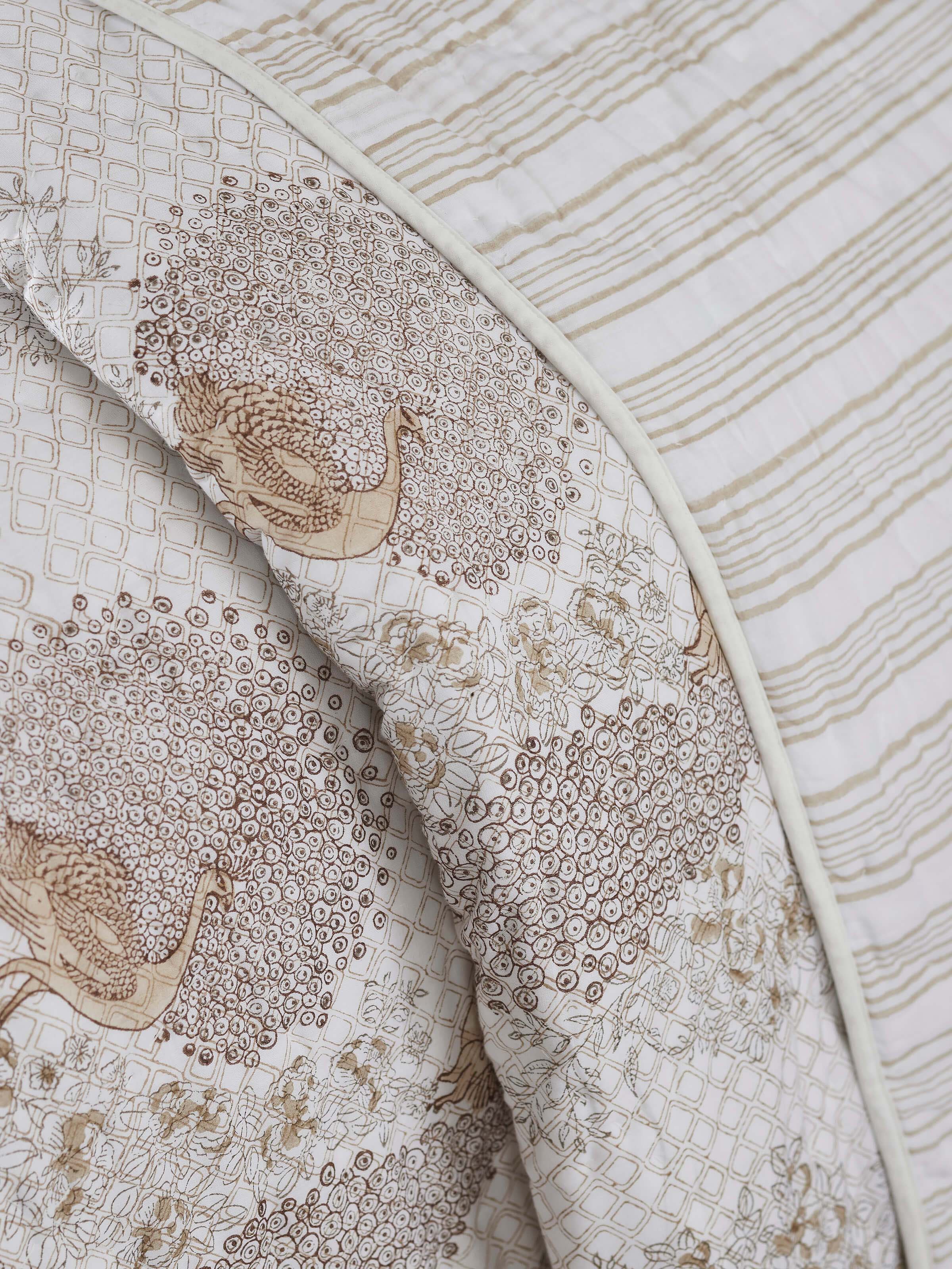 Side view of Shivranjini beige floral cotton Sanganeri block printed double quilt