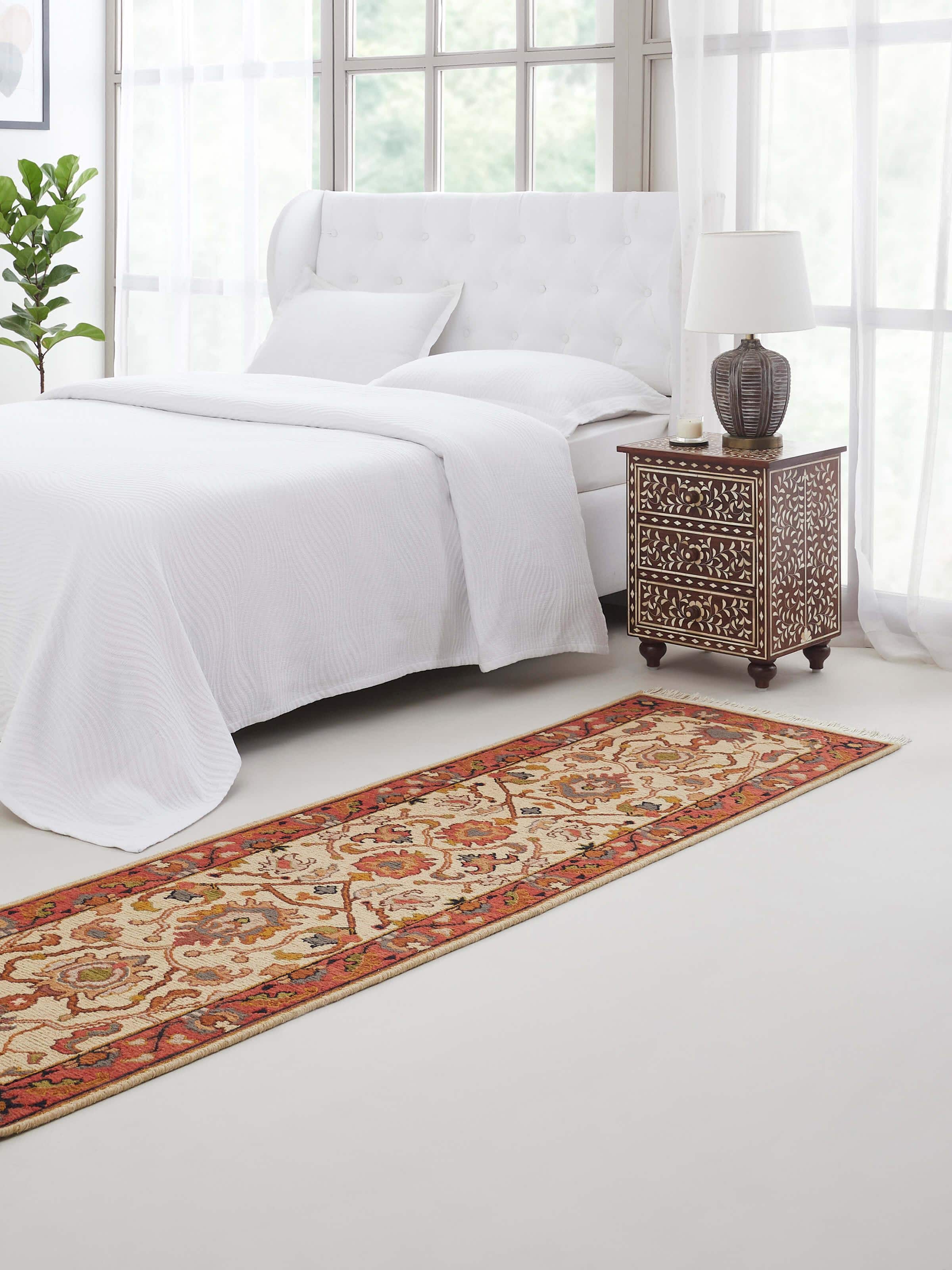 Long off-white Persian Sumak Bhadohi wool runner with intricate motifs styled in a hallway.