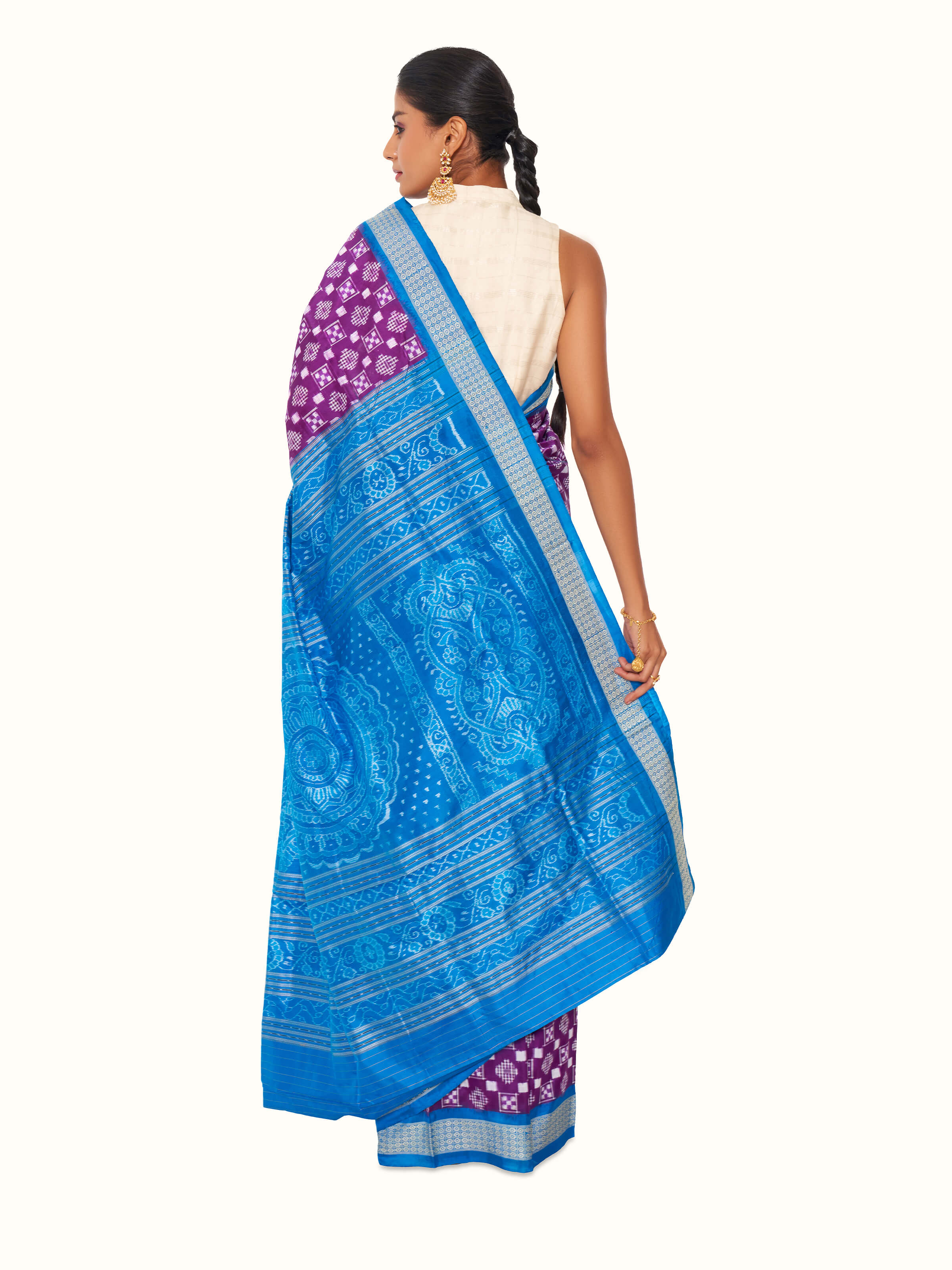 Back view of turquoise mulberry silk bandha Odisha ikat saree displaying complete pallu design