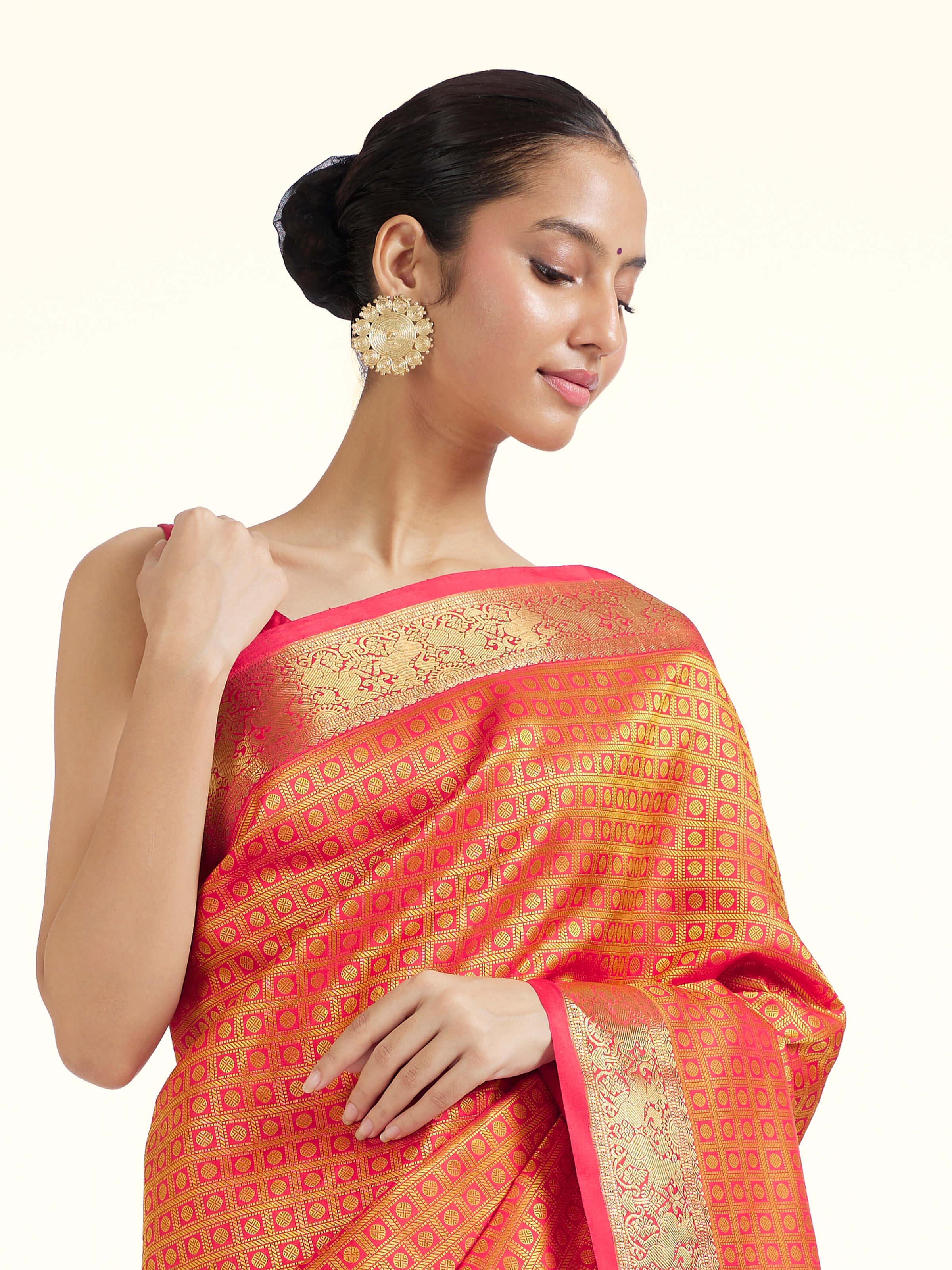 Angled view of gold silk Kancheepuram saree highlighting classic weave and radiant sheen
