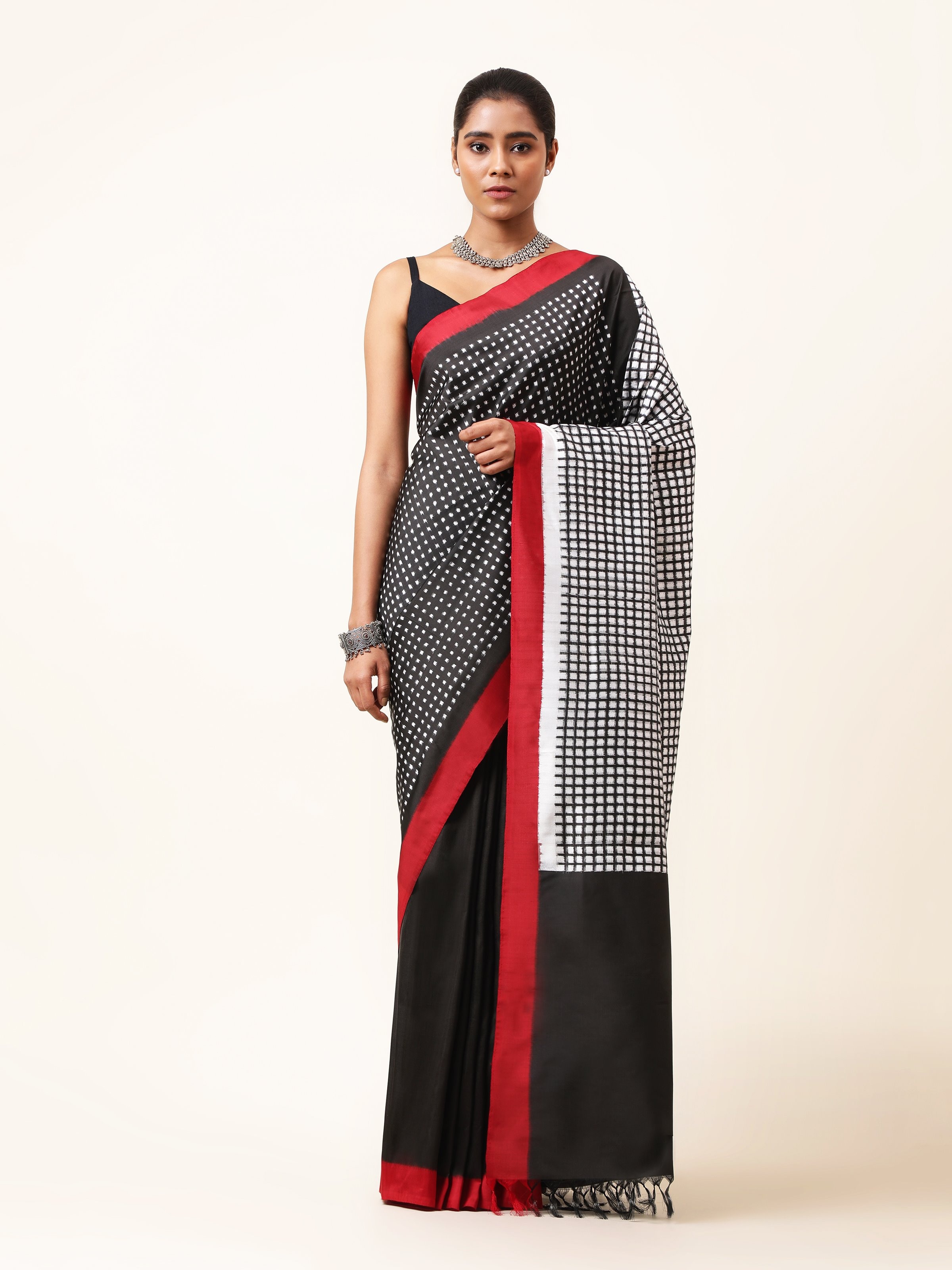 Front view of black silk double ikat saree showcasing intricate geometric patterns