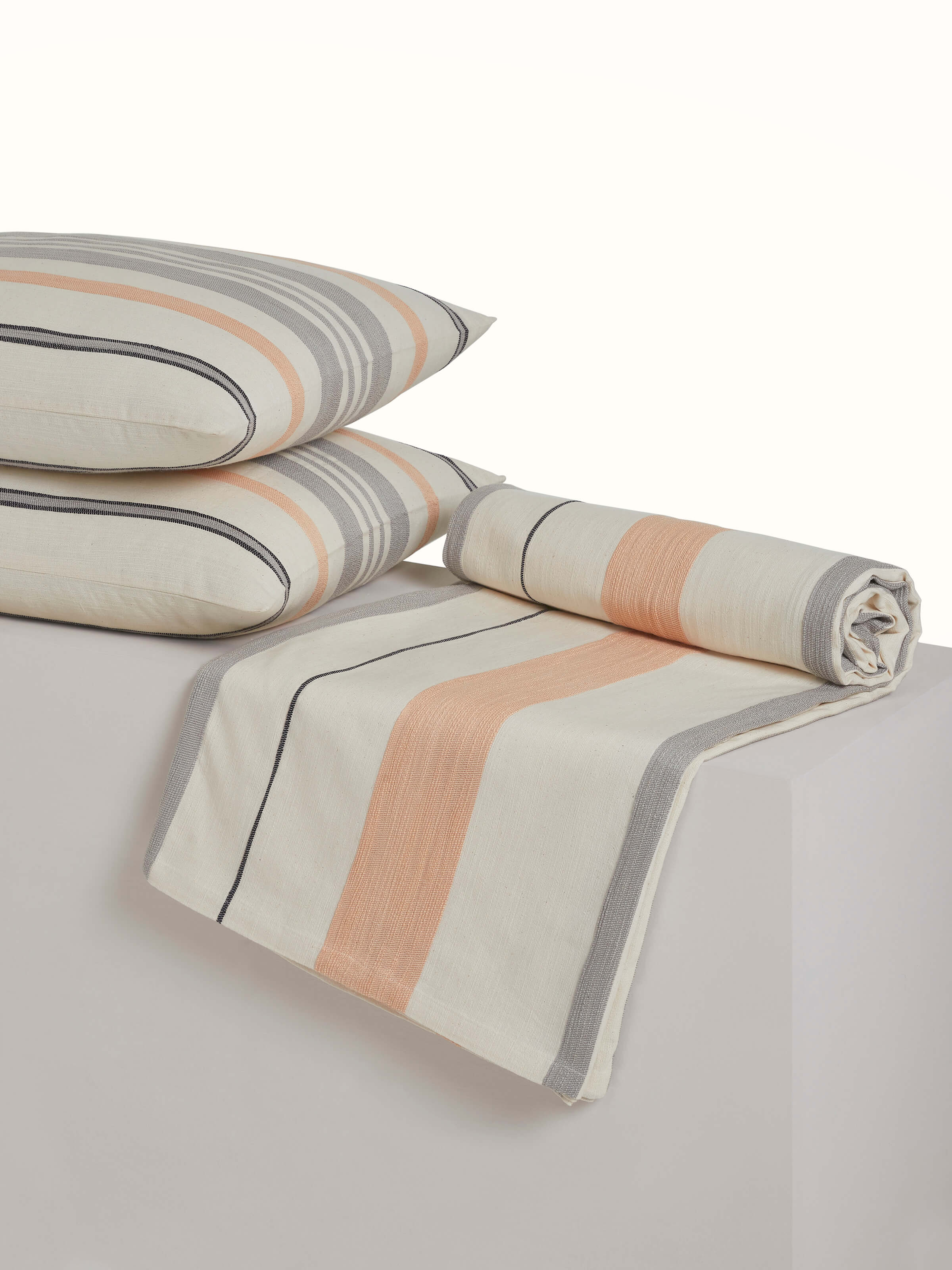 Backside view of the handloom cotton bedspread, showing neat tailoring and stripe design.