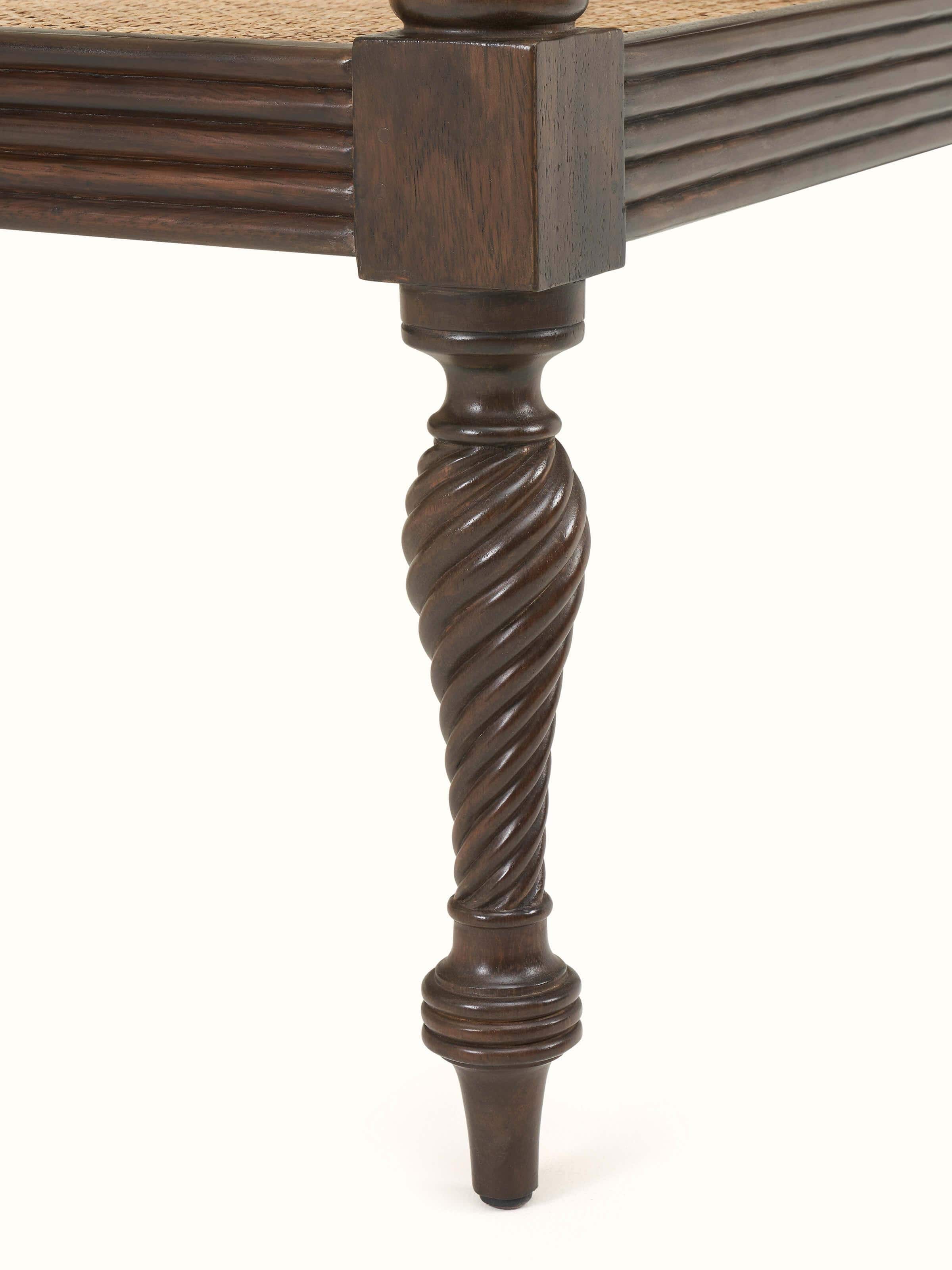 Close-up view of Walnut finish Mahogany wood and cane sofa highlighting deep wood hues and textured cane