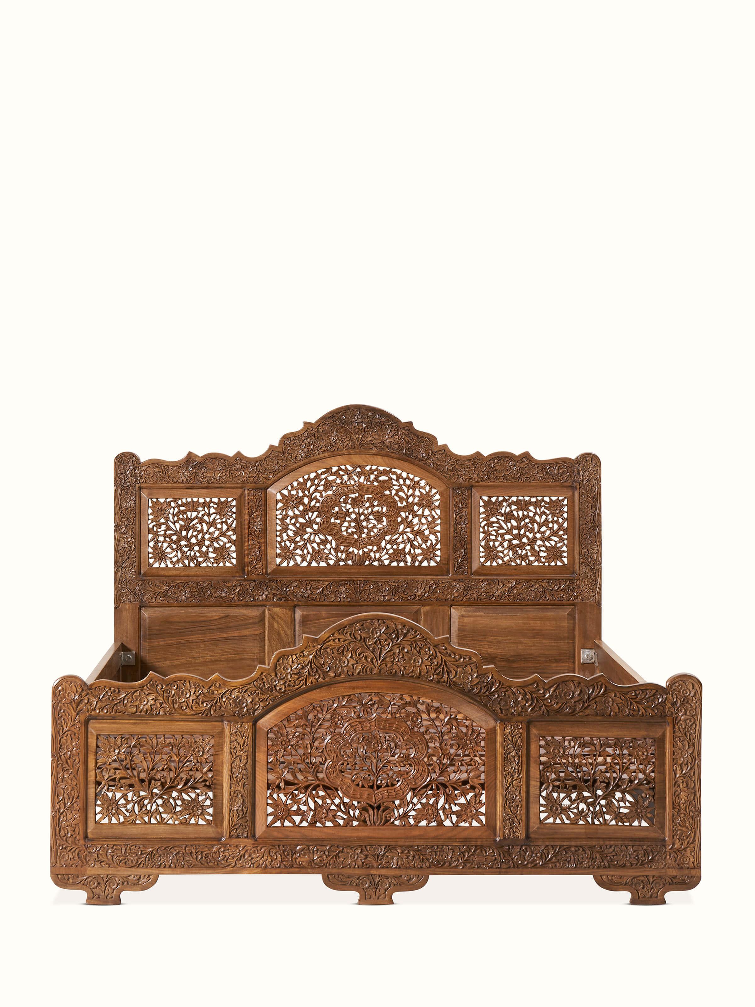 Front view of carved walnut wood queen size bed, showcasing the intricate headboard design and rich walnut finish.