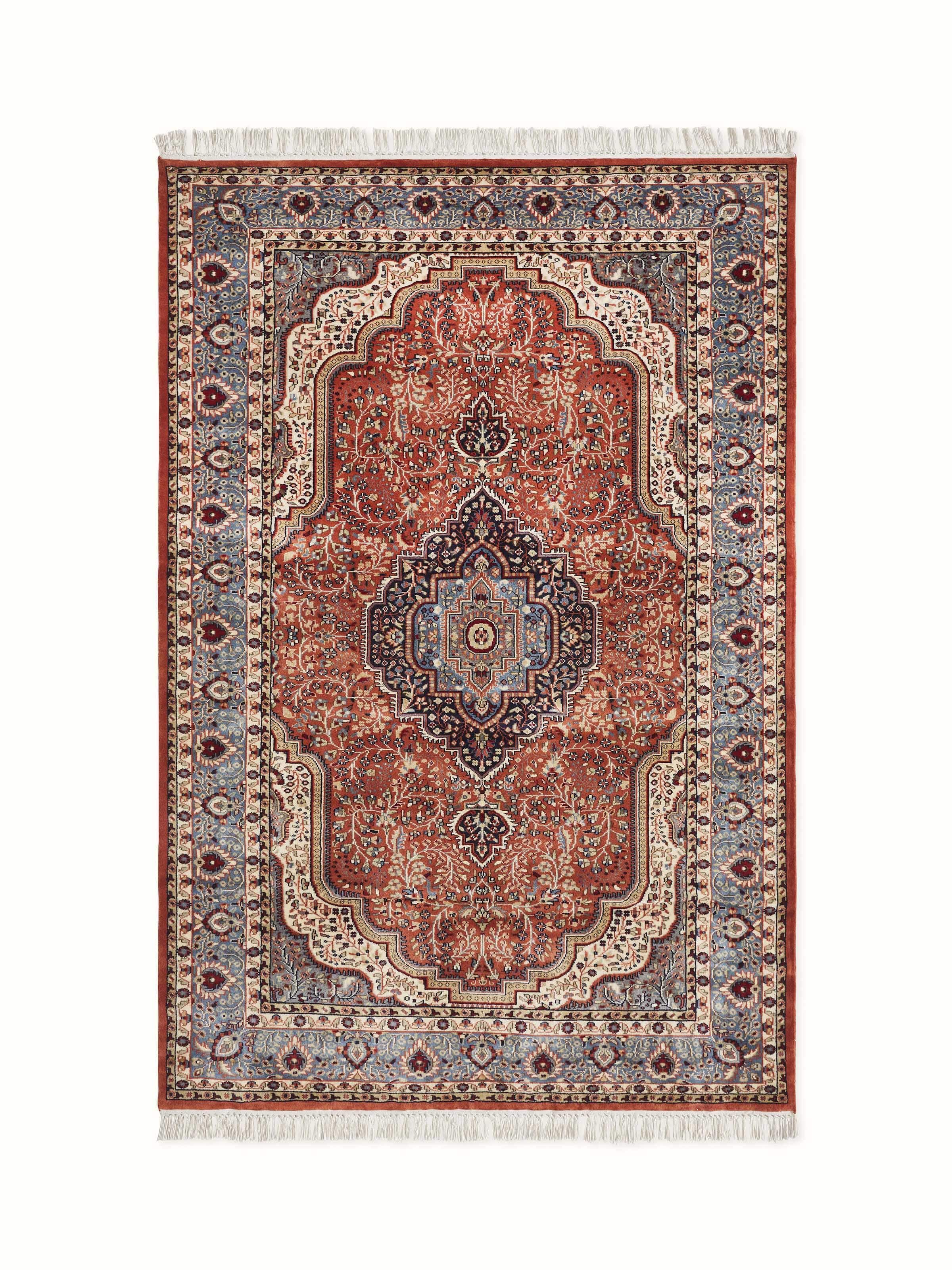 A close-up of a traditional Persian Rust Tabriz Gwalior wool hand-knotted carpet shows detailed floral motifs and warm rust tones.