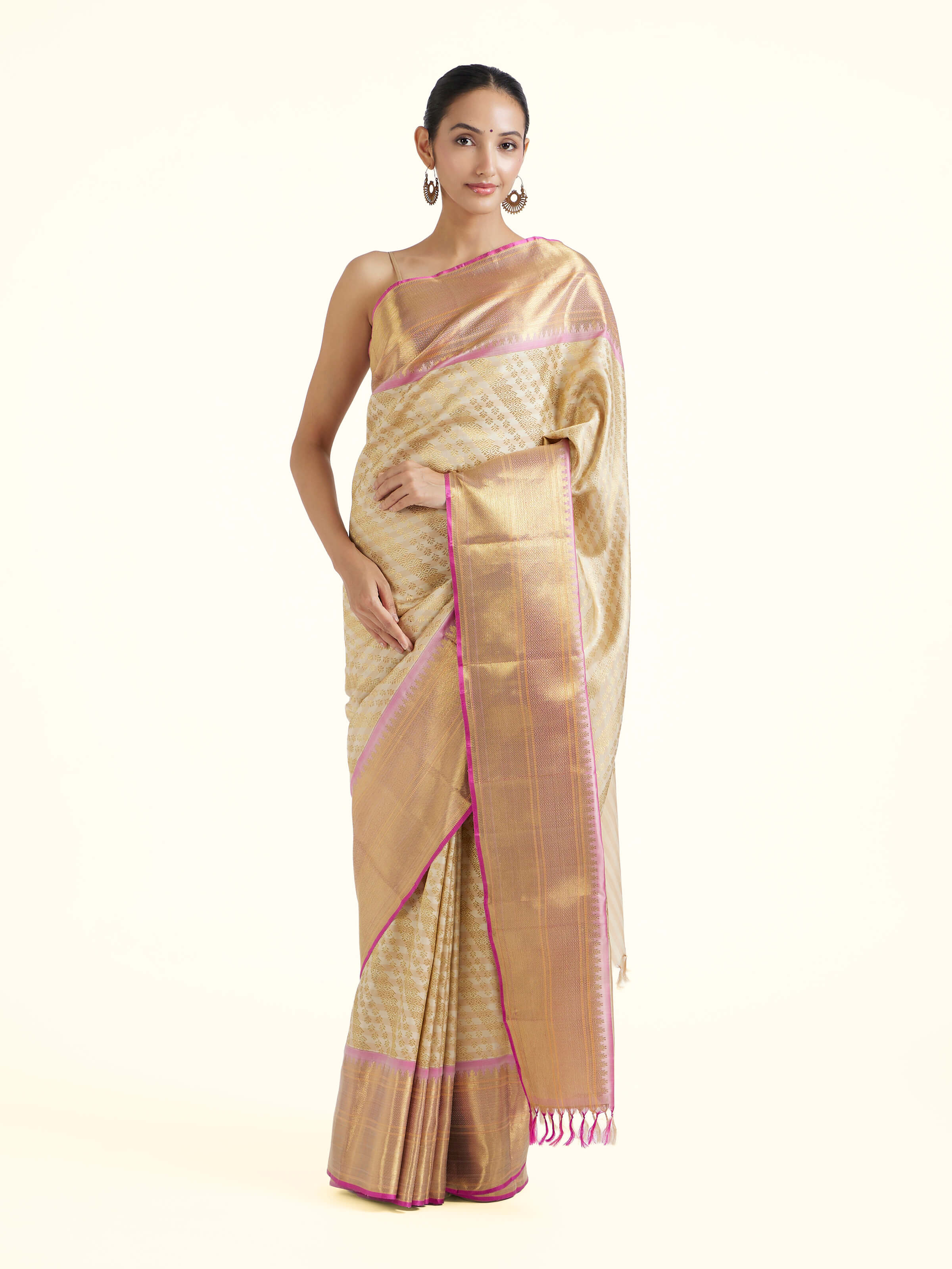 Front view of off-white silk Kancheepuram saree with rich zari woven motifs