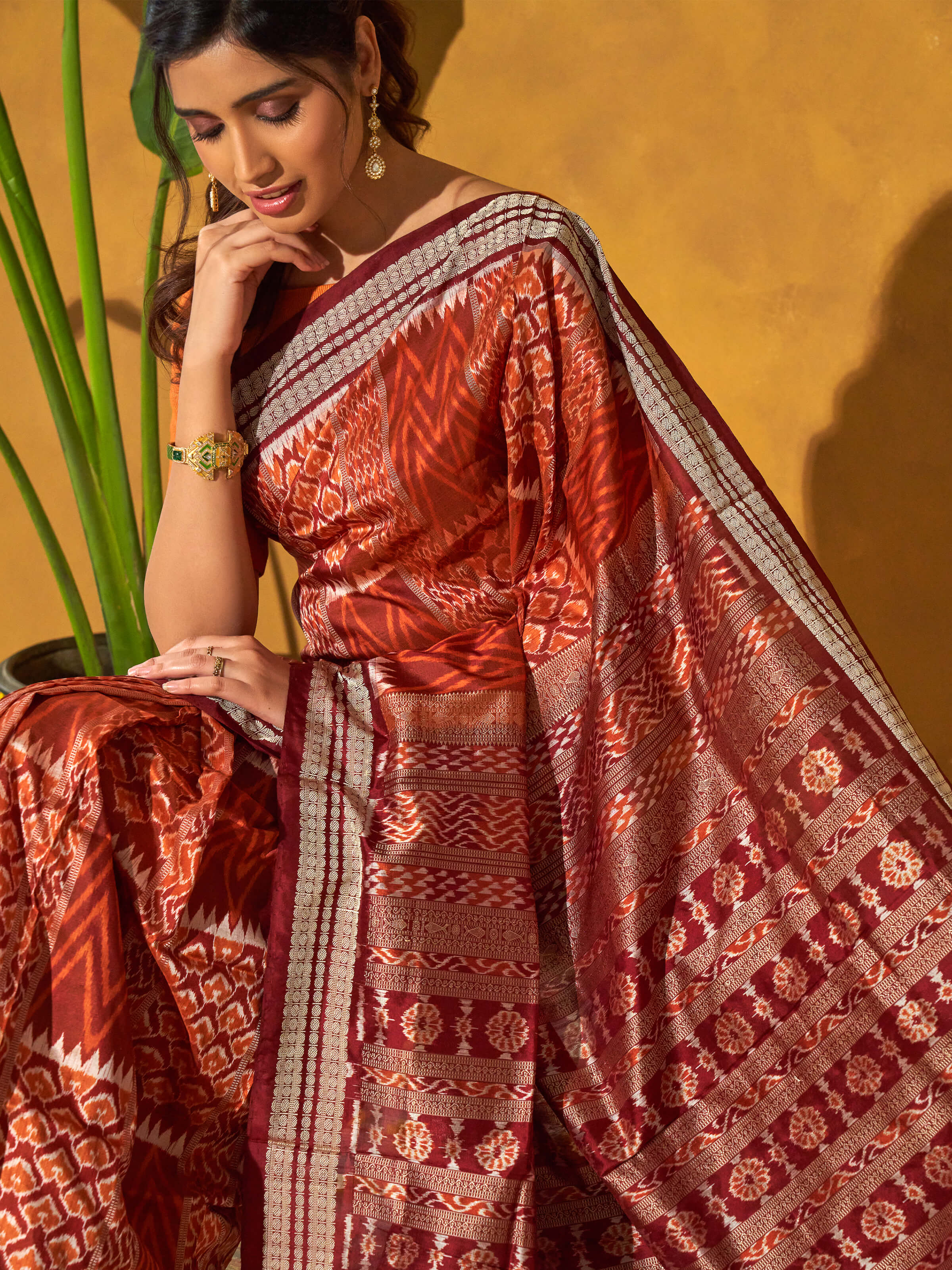 Angled view of brown mulberry silk bandha Odisha saree highlighting bandha motifs