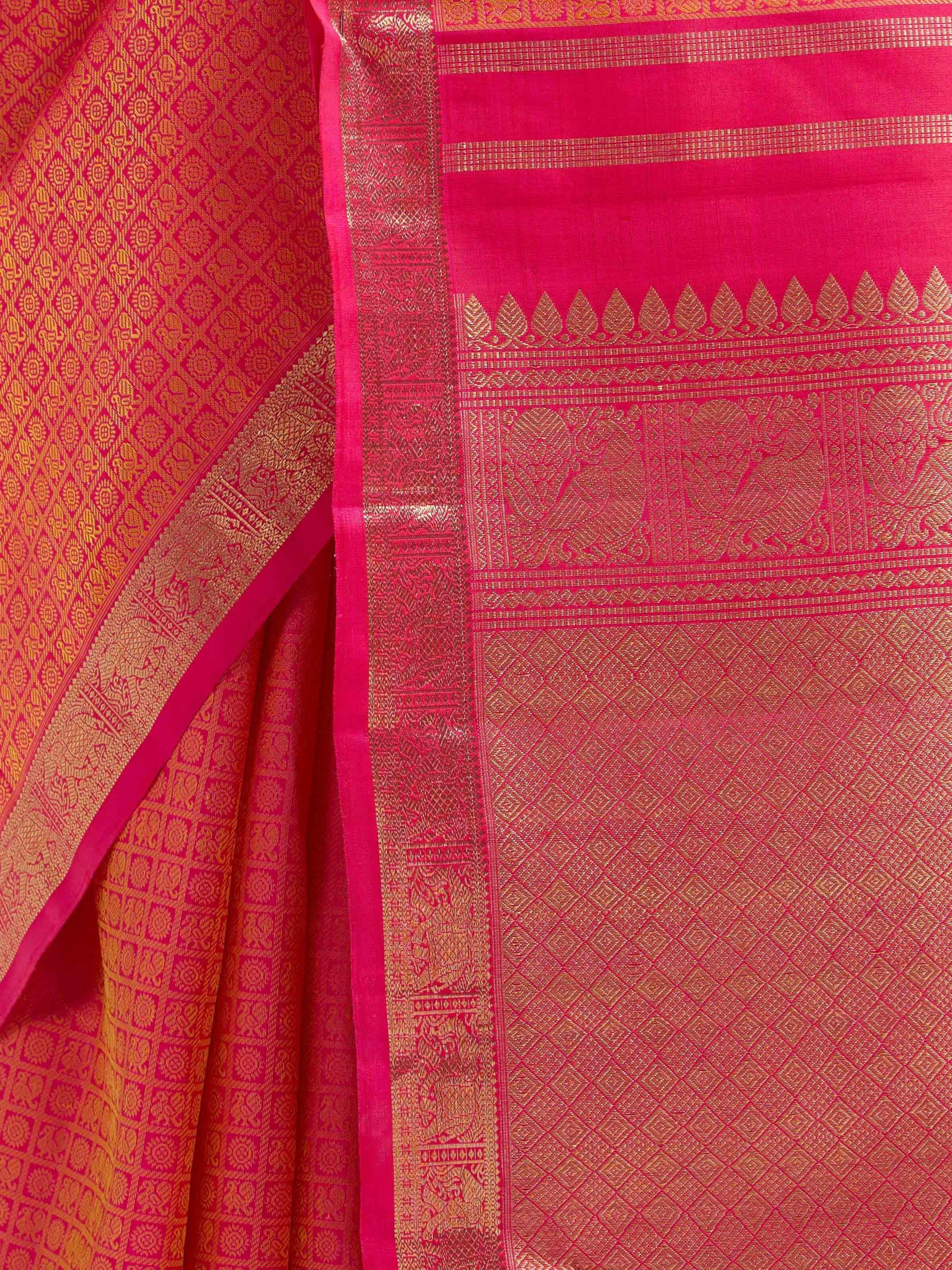 Detail view of orange silk Kancheepuram saree showing silk texture and zari craftsmanship