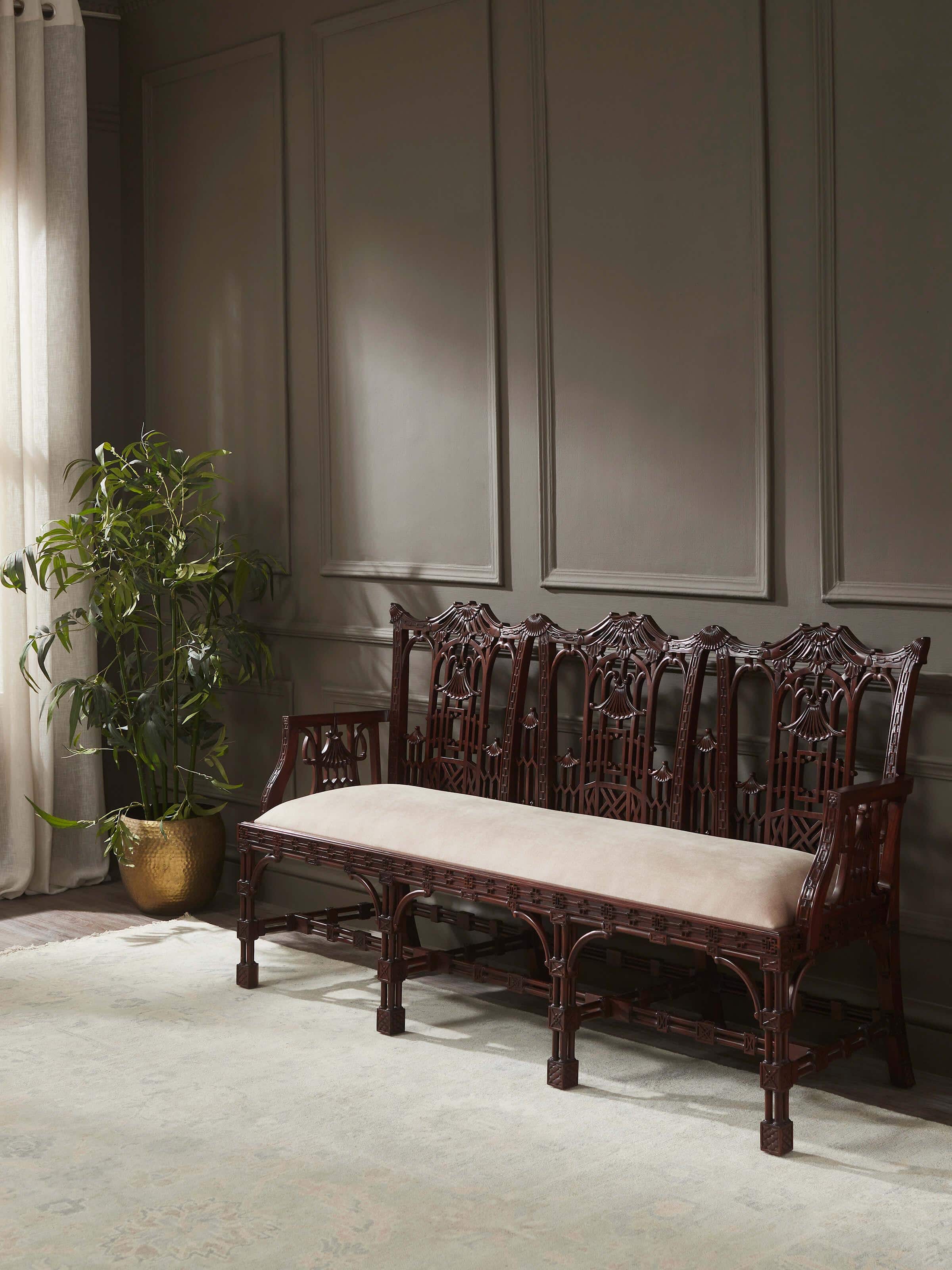 Lifestyle view of upholstered mahogany 3-seater sofa placed in a classic interior setting