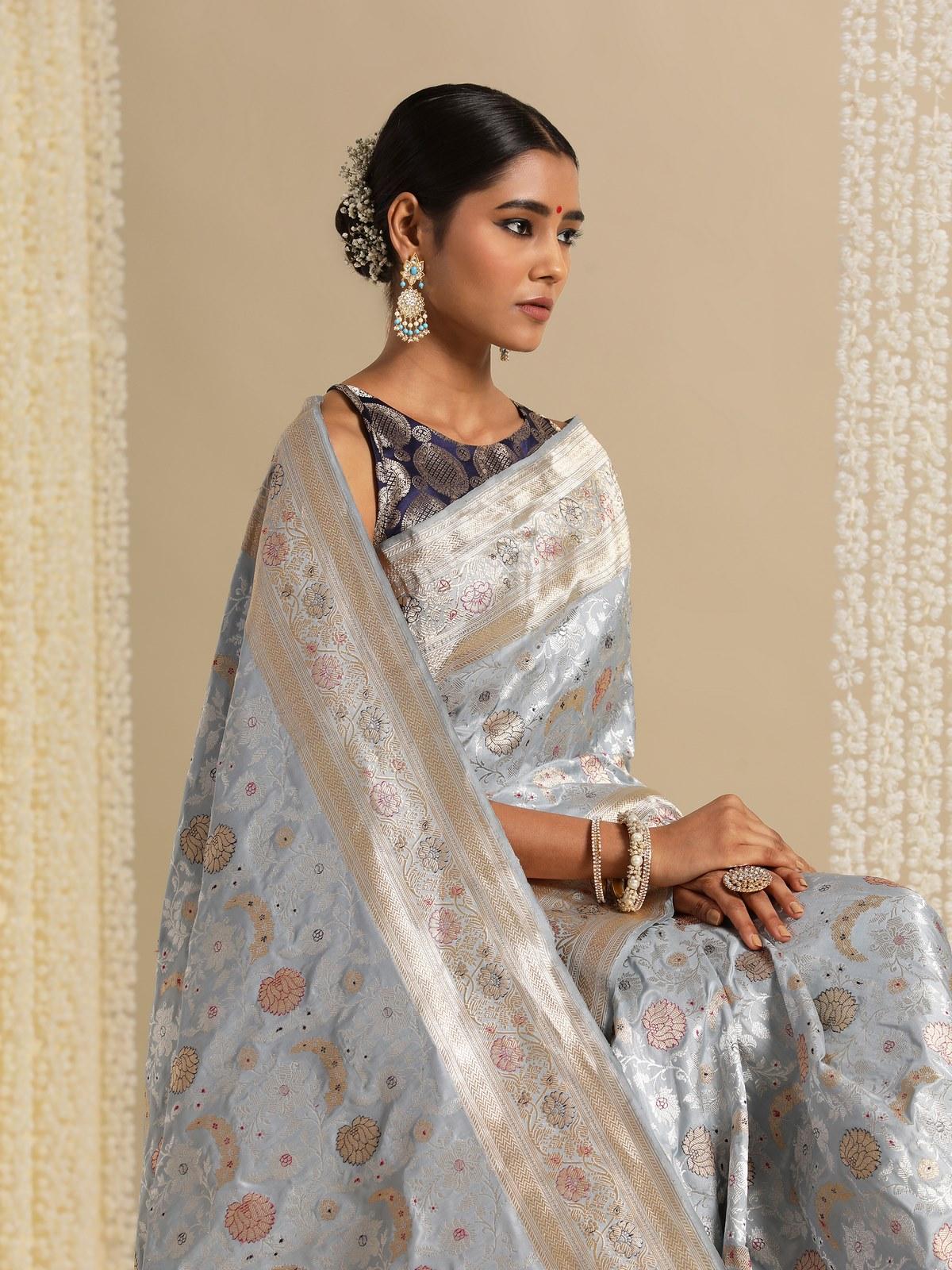 Detail shot of ice blue Banarasi saree showcasing intricate weave and pallu design.