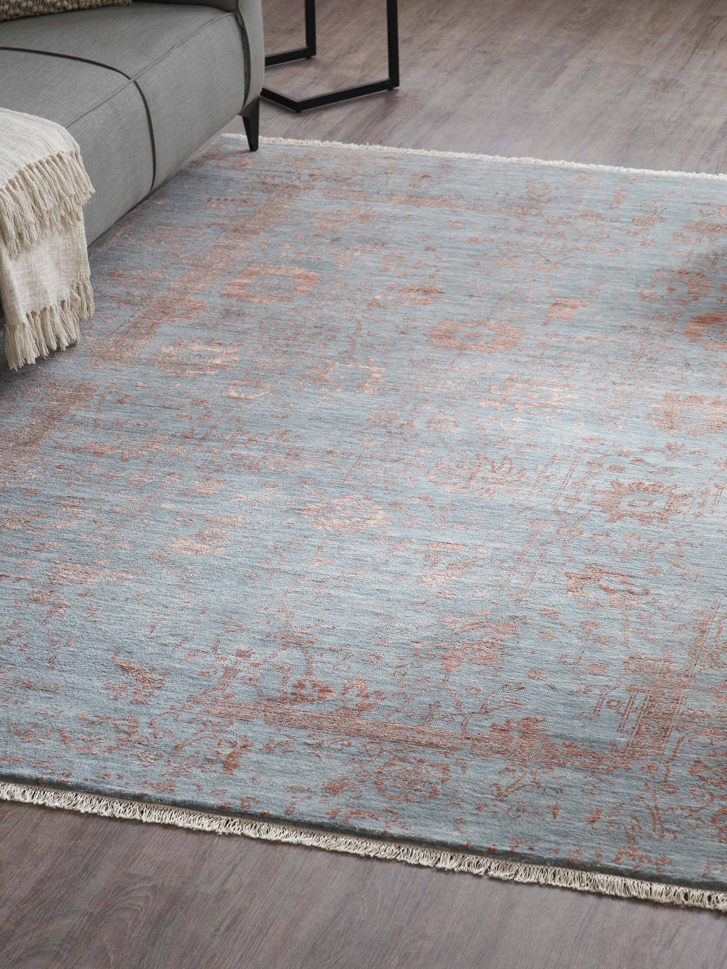 Dark grey and copper transitional Agra hand-knotted wool and viscose rug styled in room