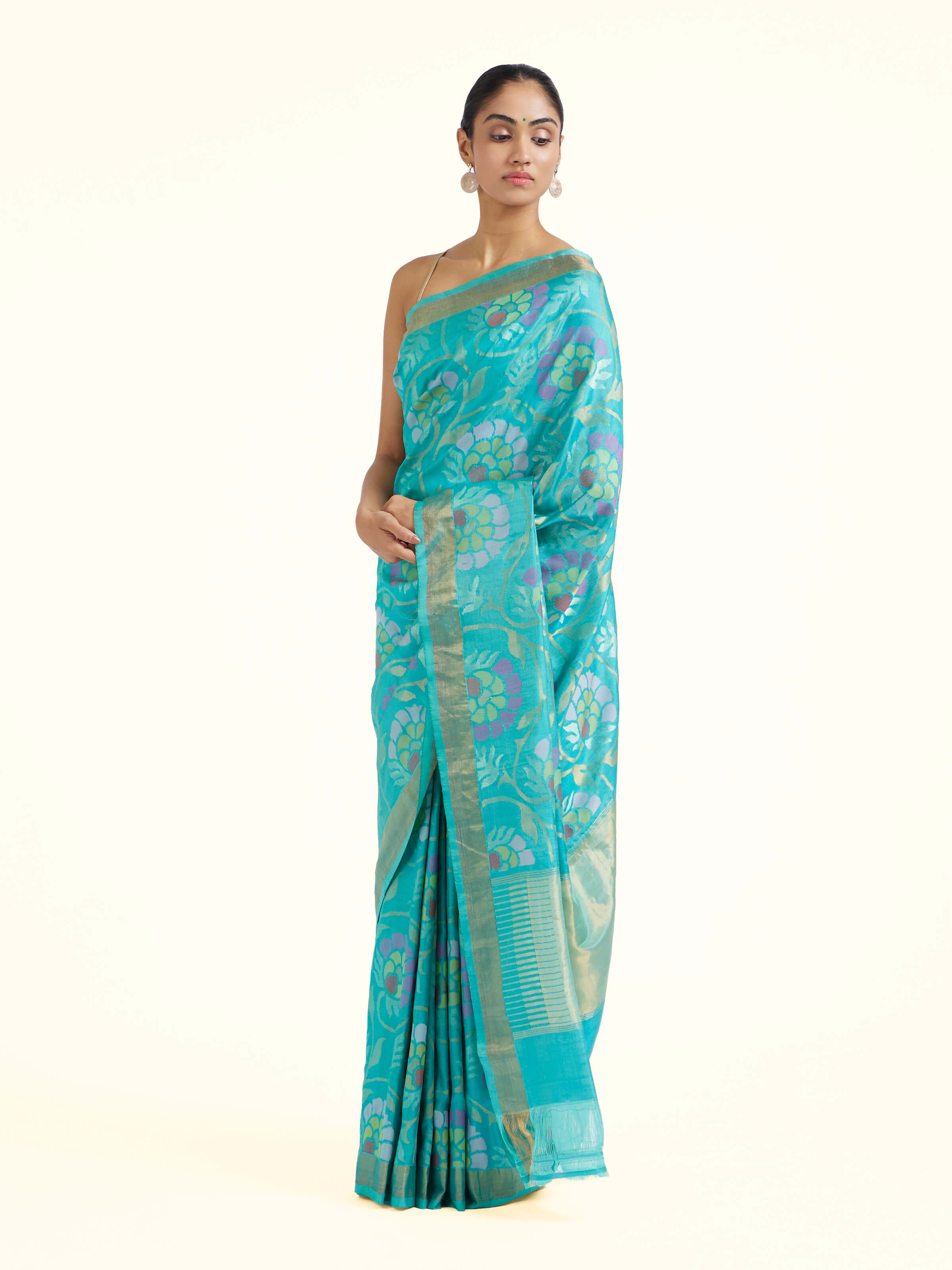 Side view of turquoise mulberry silk Uppada Jamdani saree with graceful drape