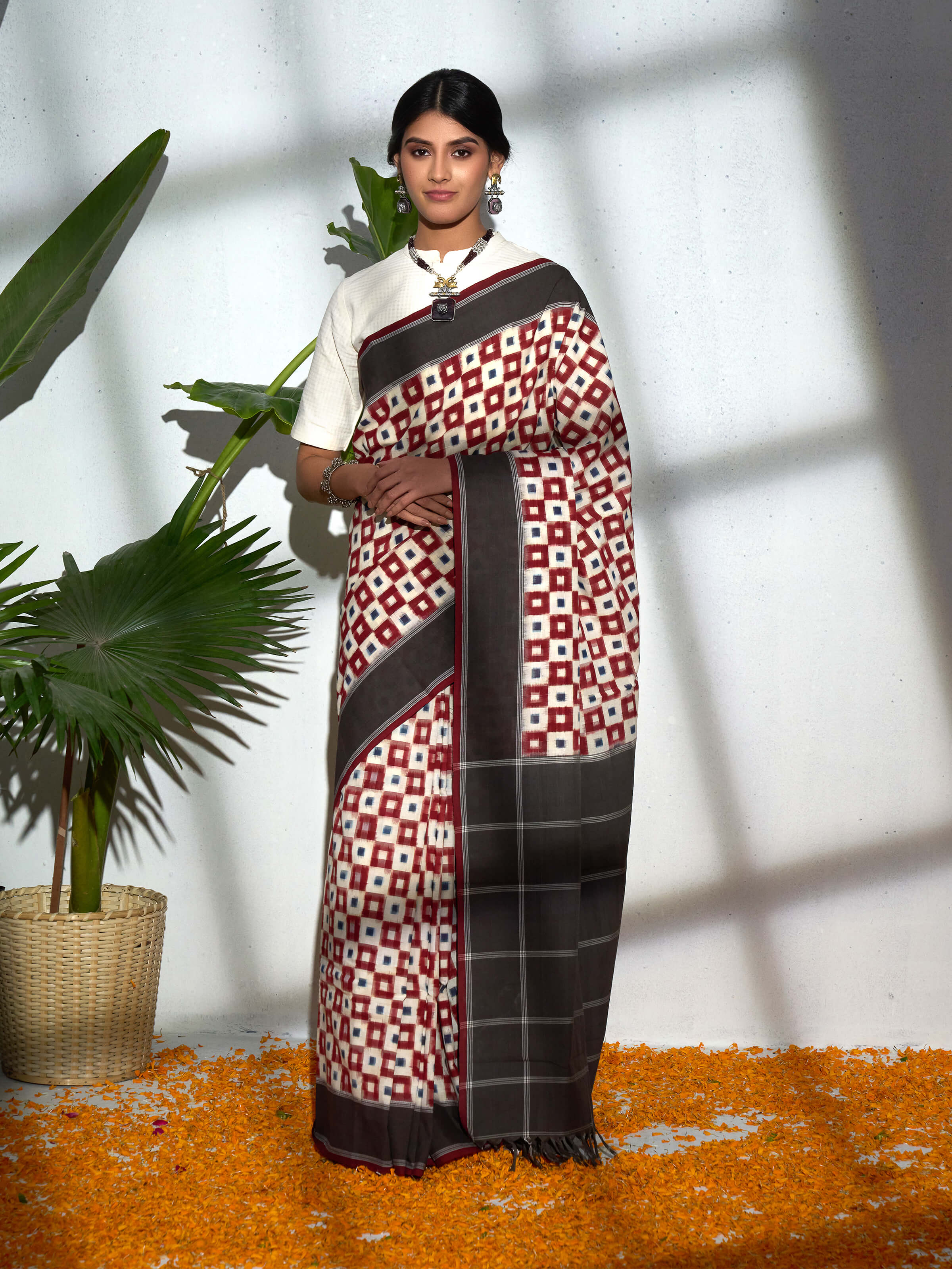 Side view of brown cotton double ikat saree showcasing border and weave