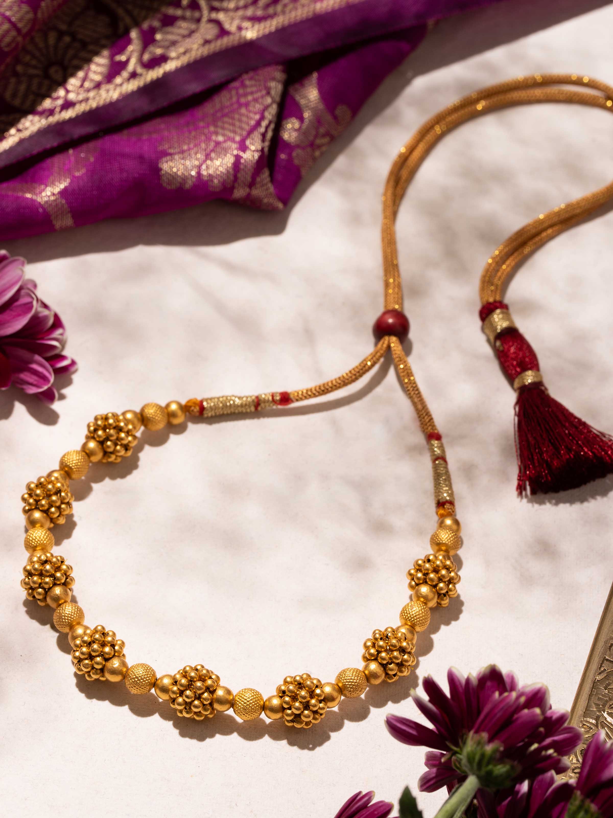 Thushi gold collar necklace close-up on display – Swadesh