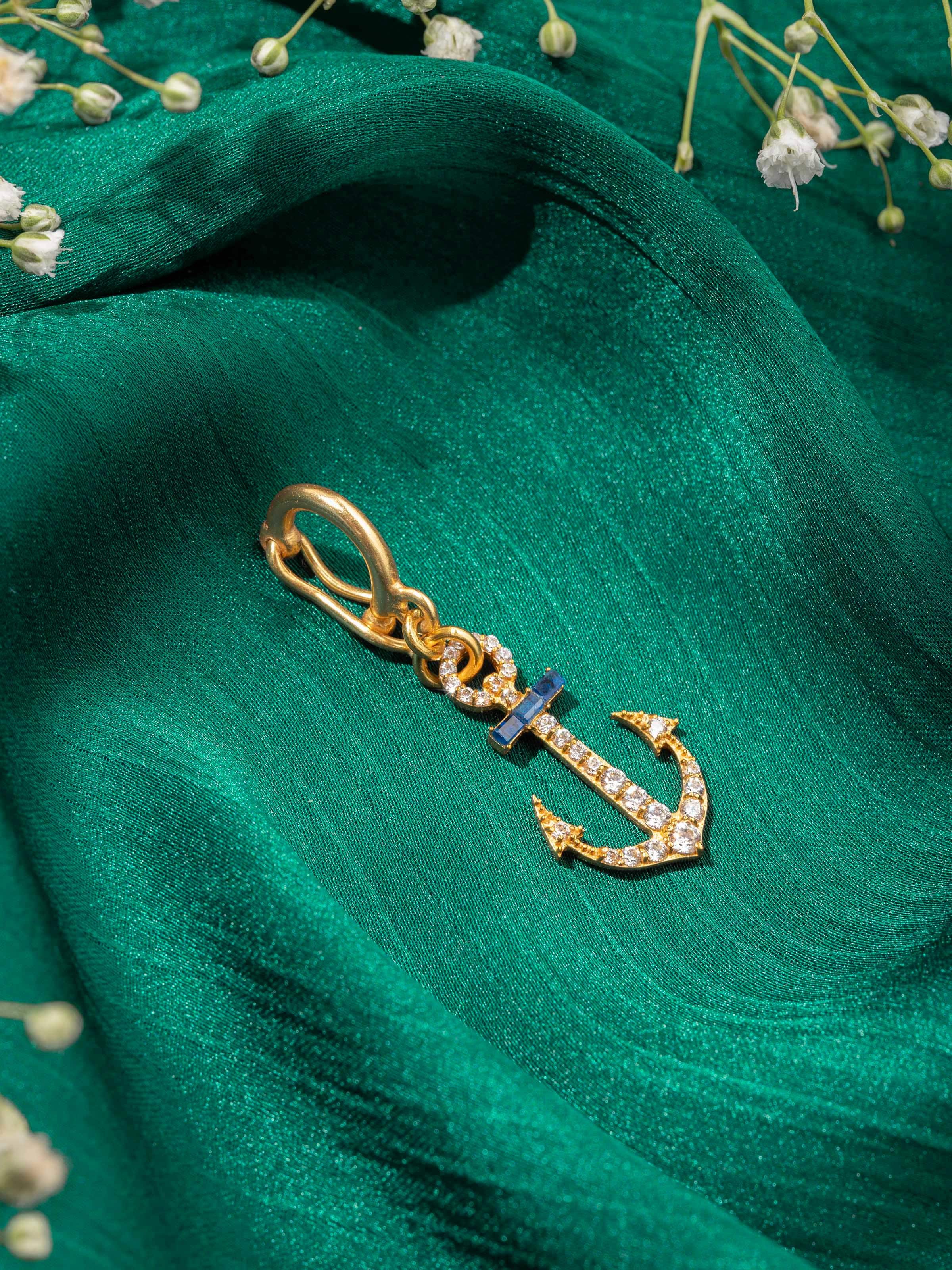 Close-up of silver pendant worn on neckline, highlighting detailed engraving and antique tone.