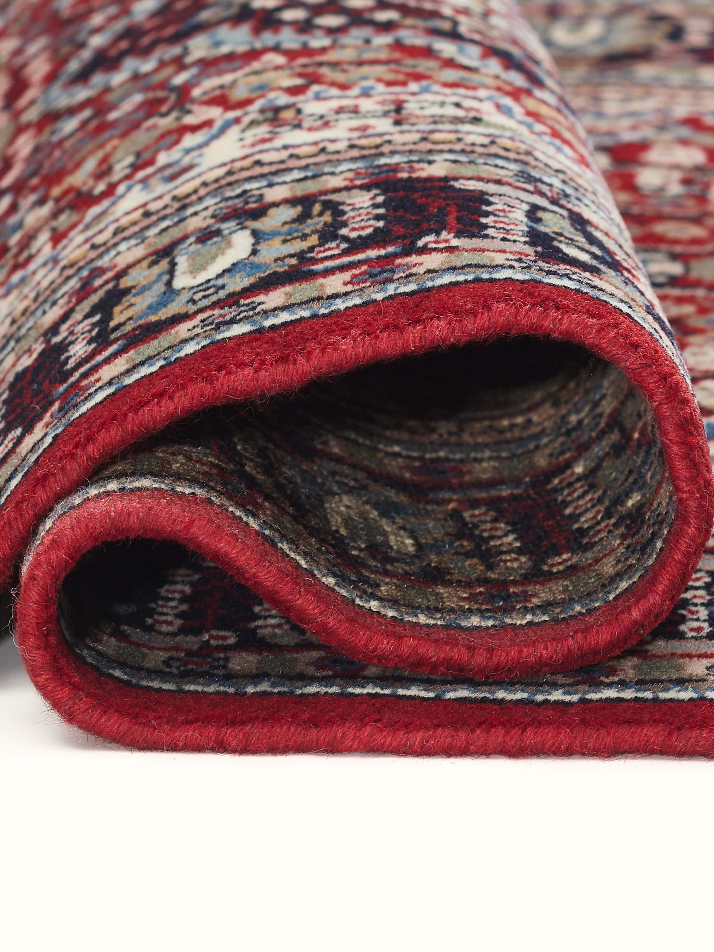 Detailed view of Persian red Oriental Gwalior wool carpet highlighting texture and craftsmanship of the knotting.