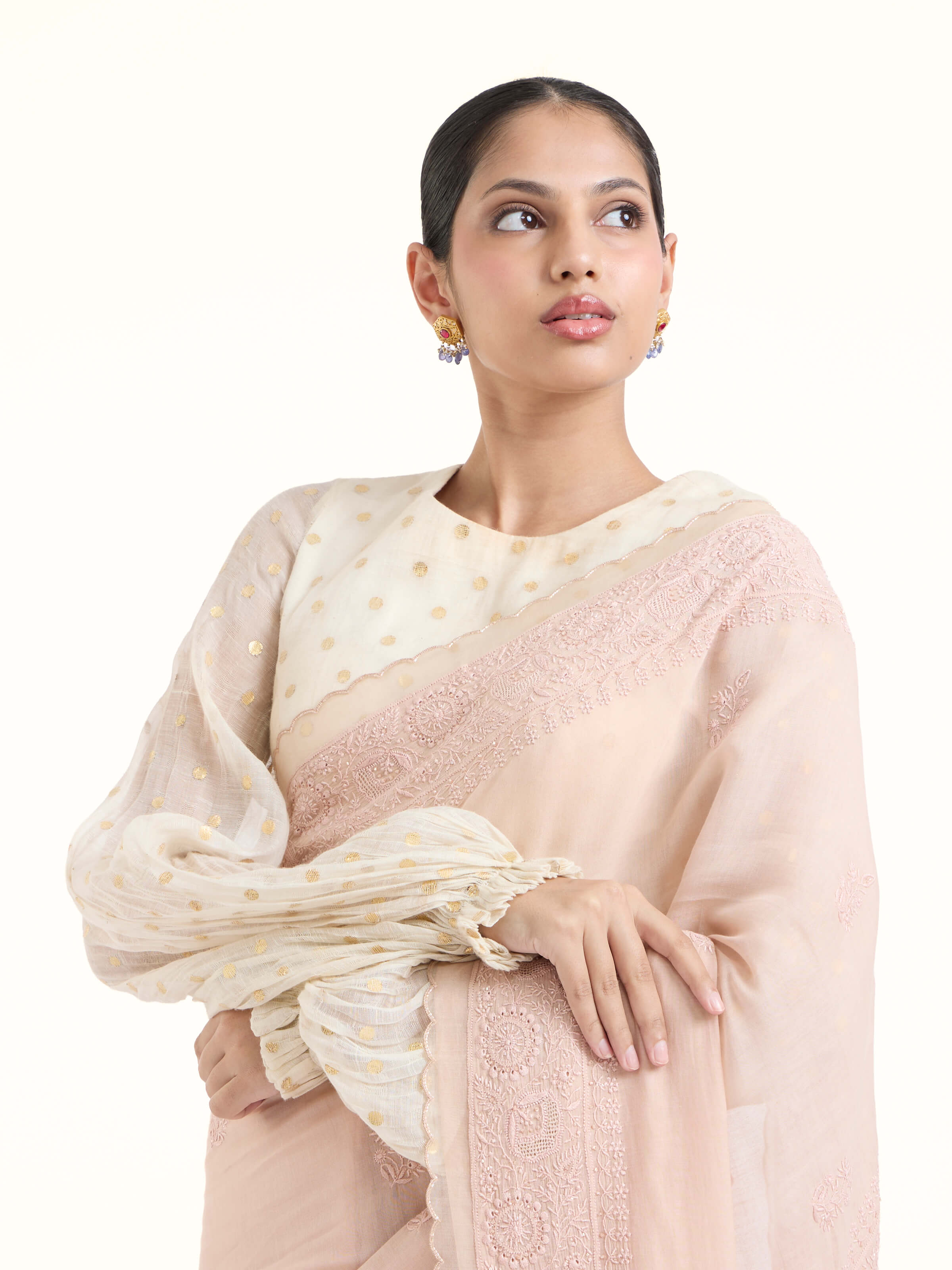 Angled view of pink cotton silk chikankari saree highlighting chikankari work