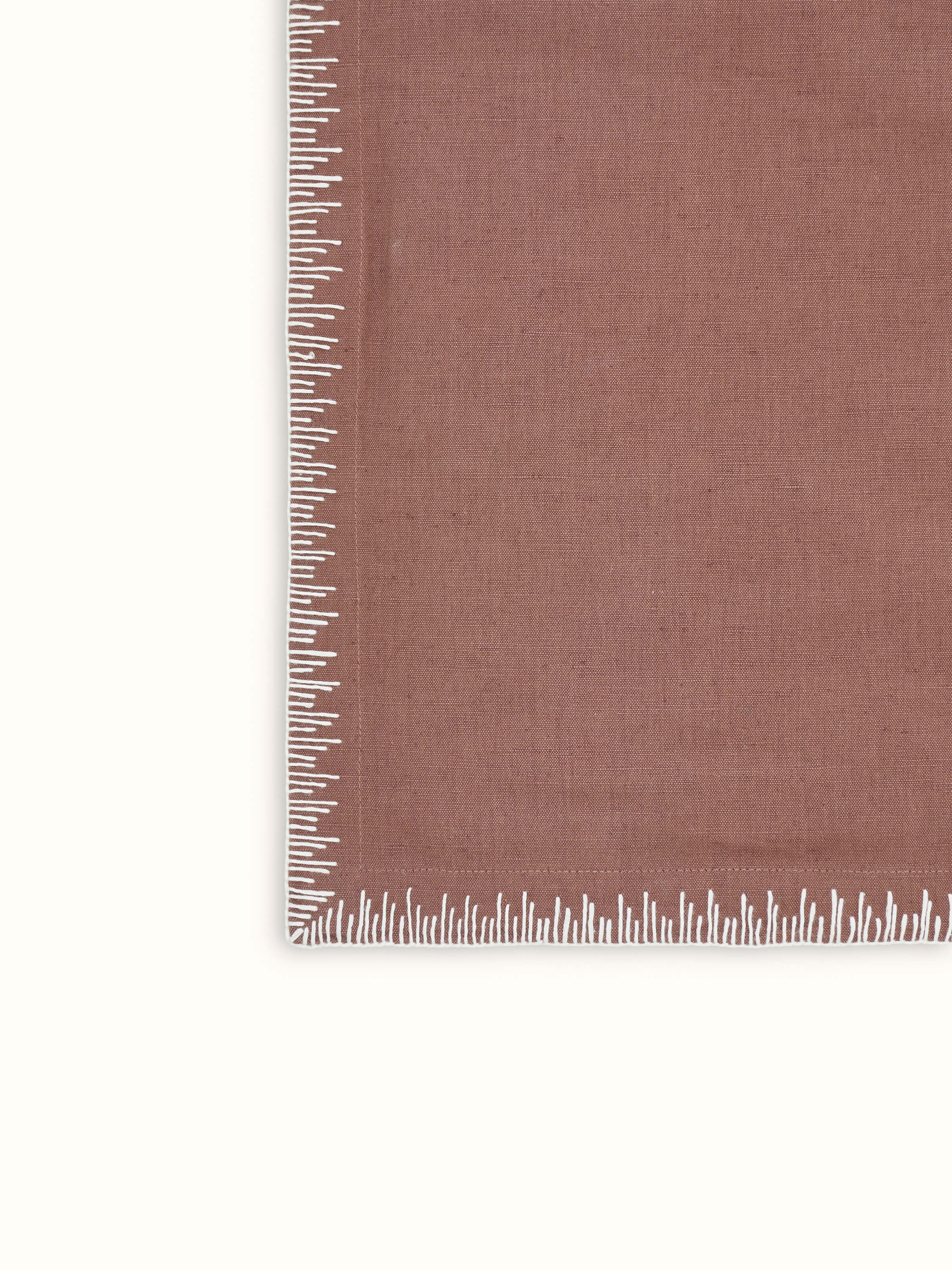 Texture and fabric detail of linen cotton brown embroidered table mat