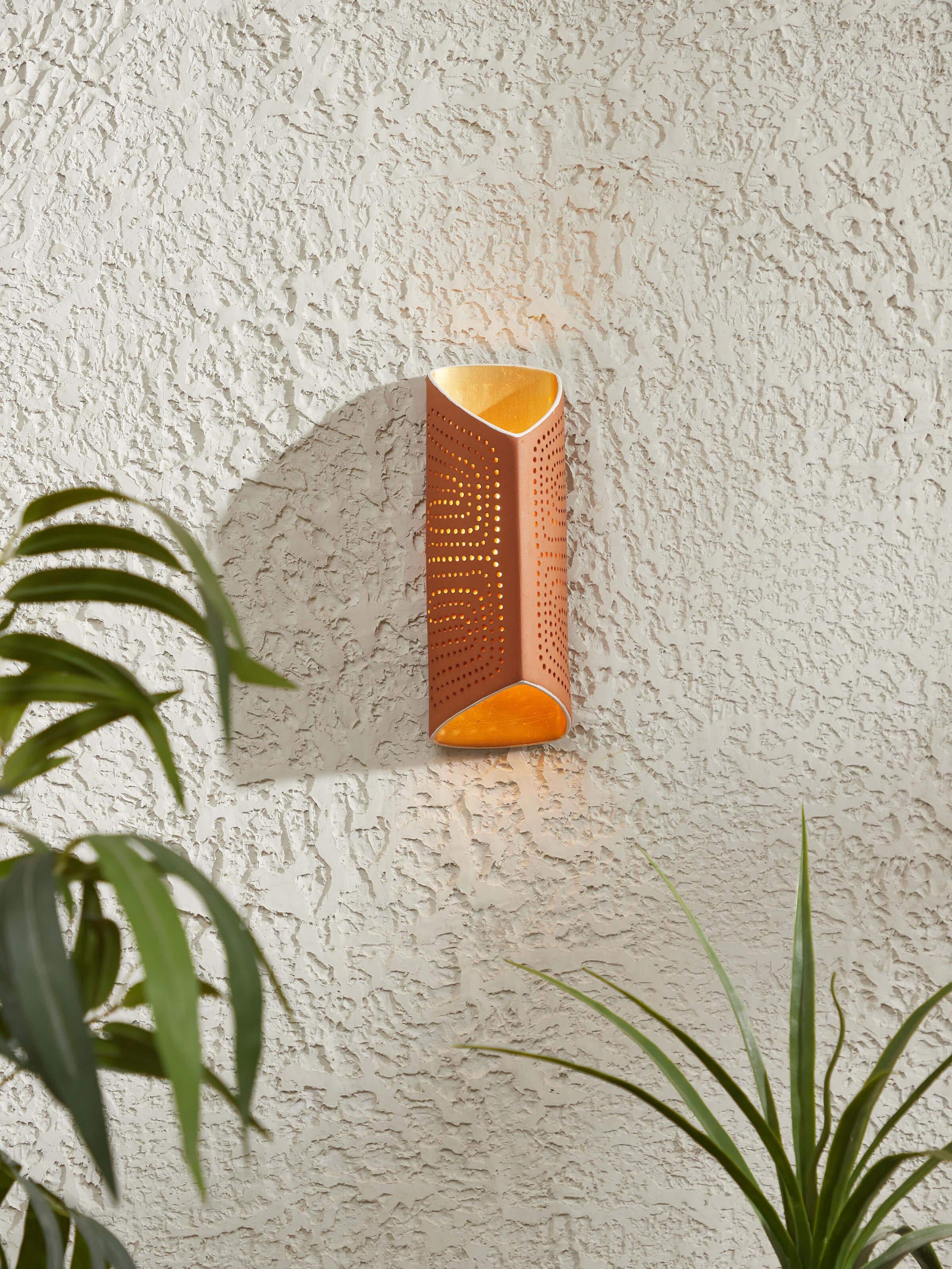 Side view of terracotta wall light showcasing the texture and traditional terracotta craftsmanship