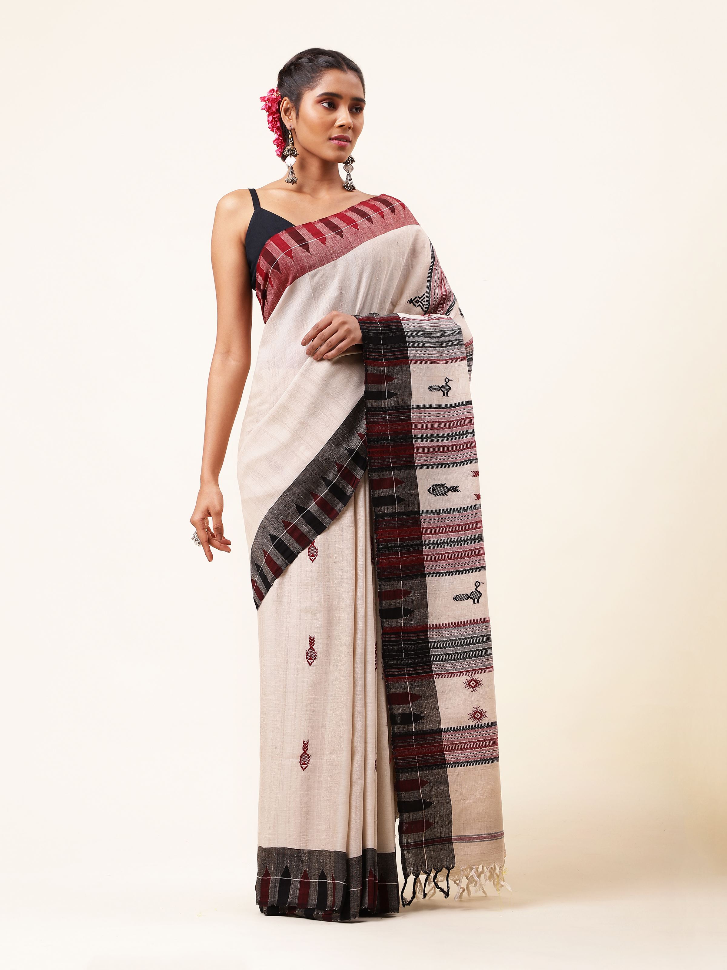 Front view of off-white cotton Tussar silk Kotpad saree with tribal patterns.