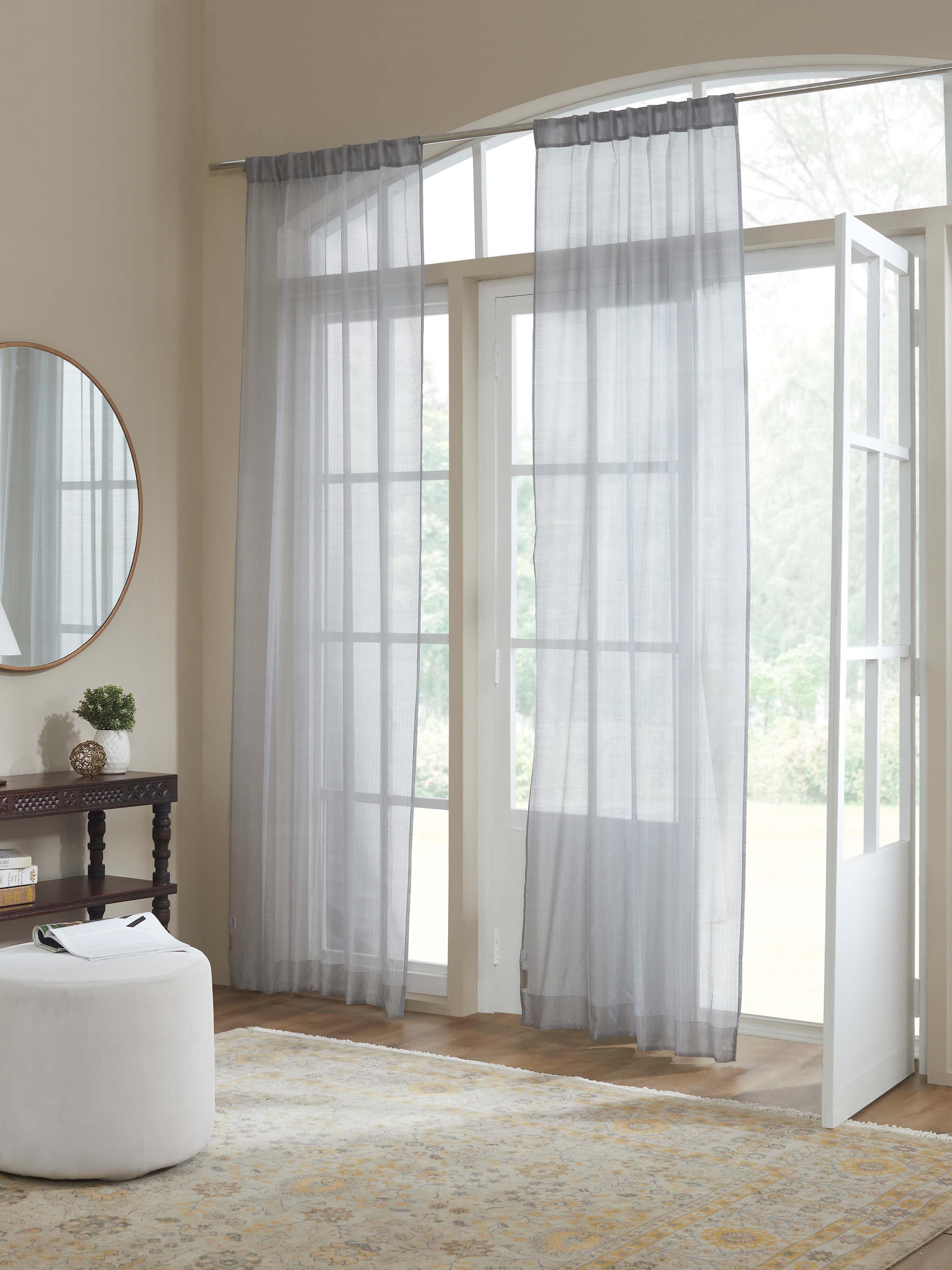 Lifestyle setting showcasing sheer Maheshwari curtain with grey and metallic striped texture in natural light.