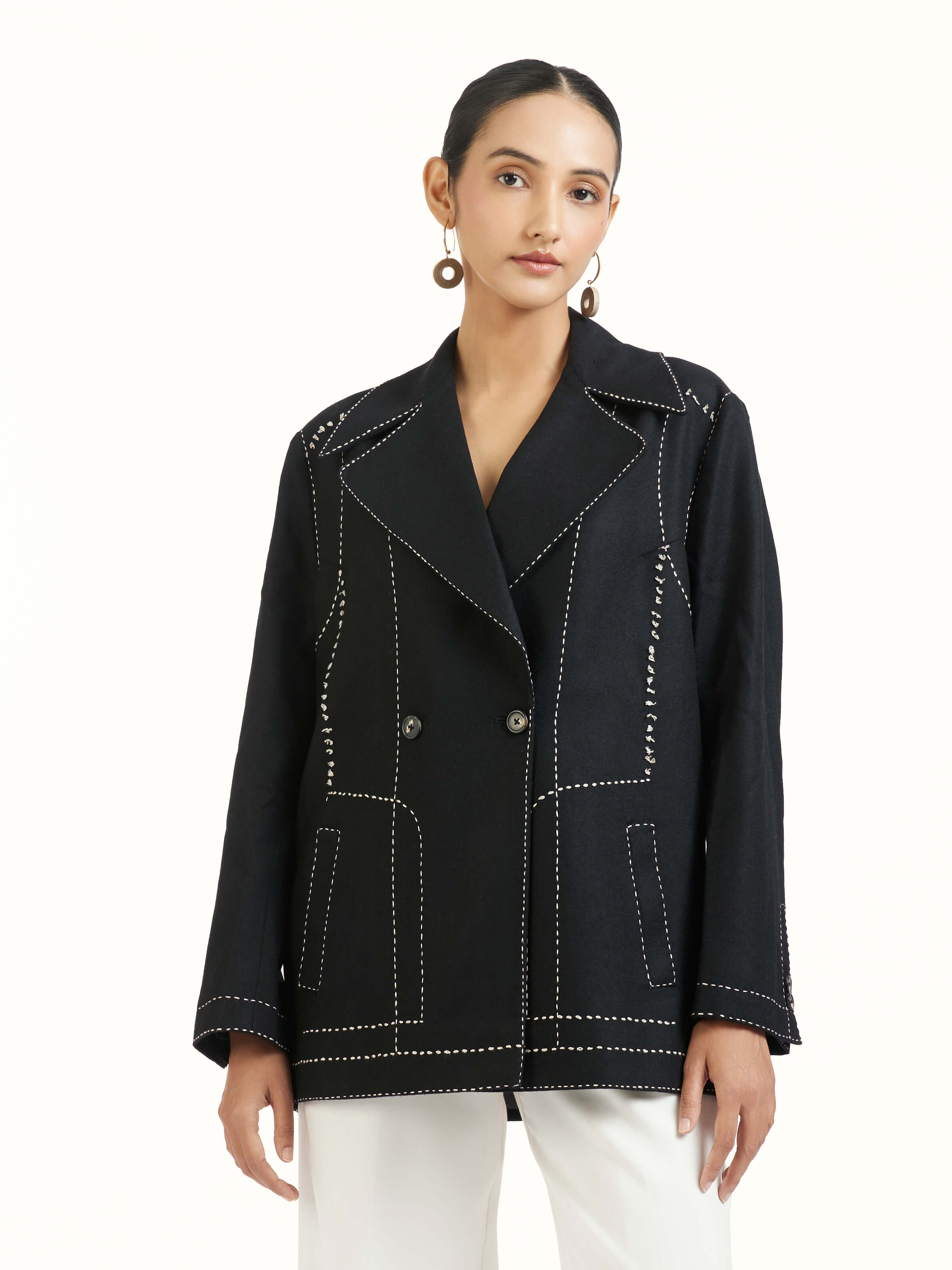 Angled view of black wool kantha jacket highlighting kantha stitch work