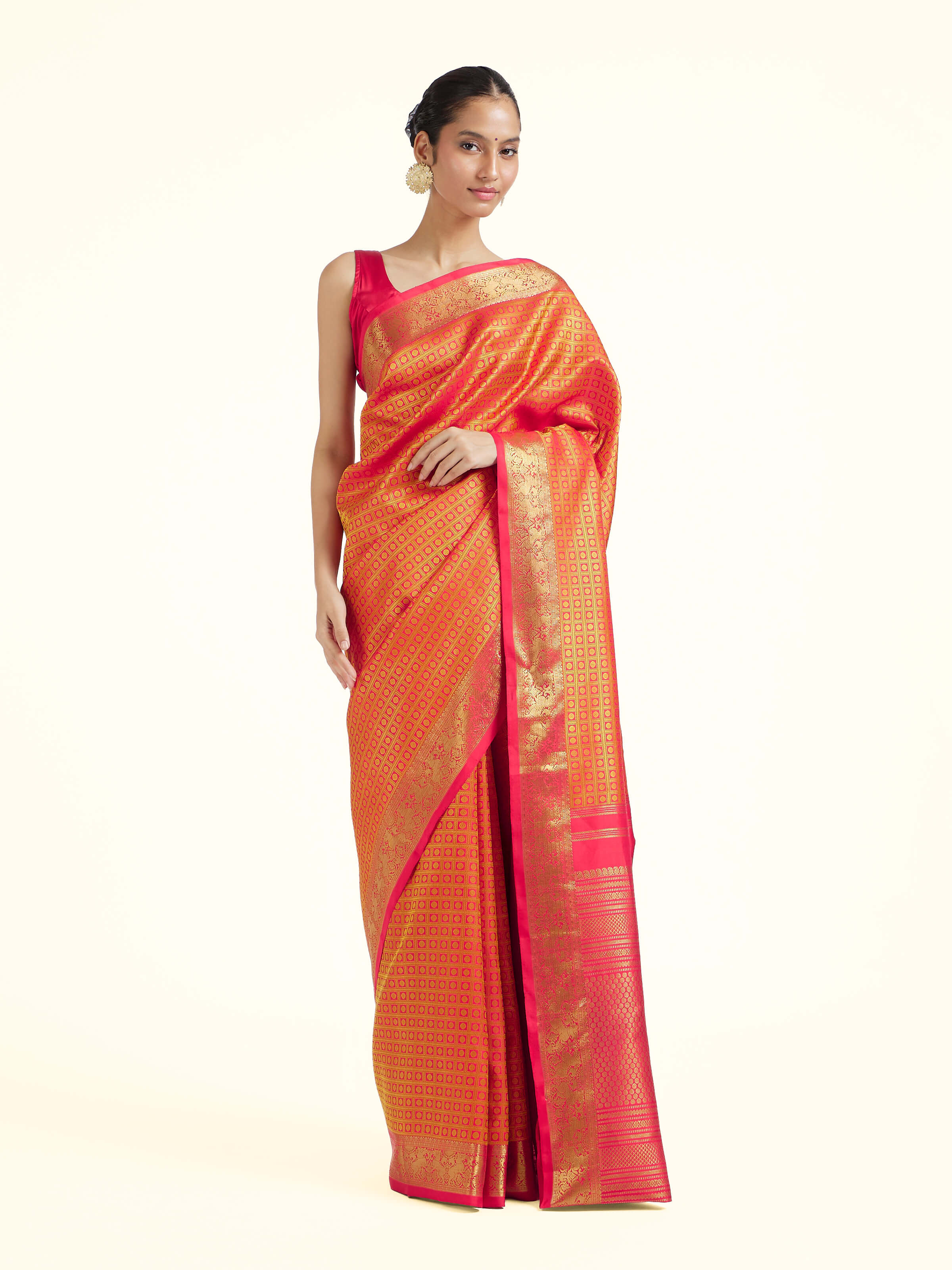 Front view of gold silk Kancheepuram saree with rich zari woven motifs