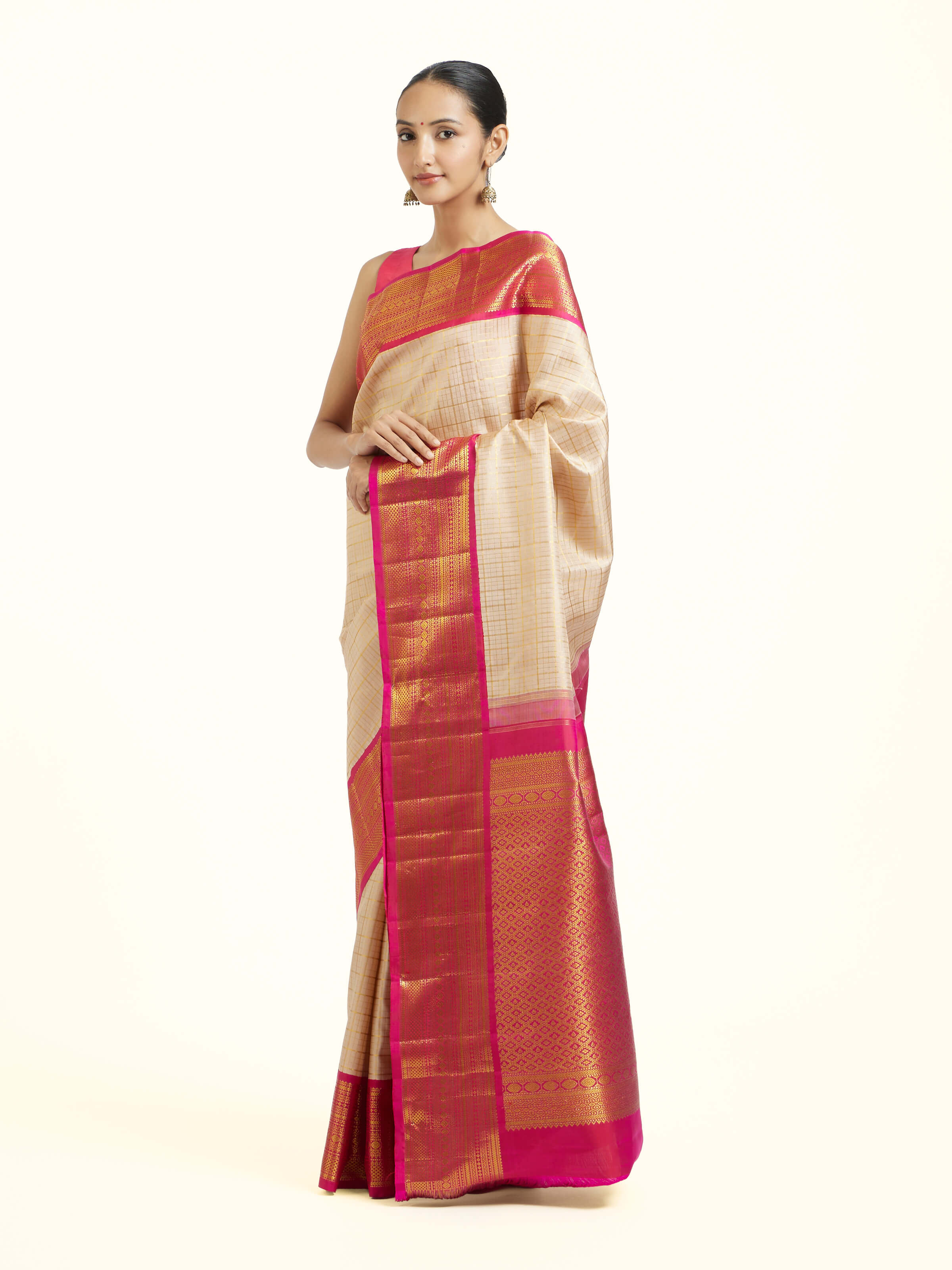 Side view of cream silk Kancheepuram saree with graceful drape and contrast border