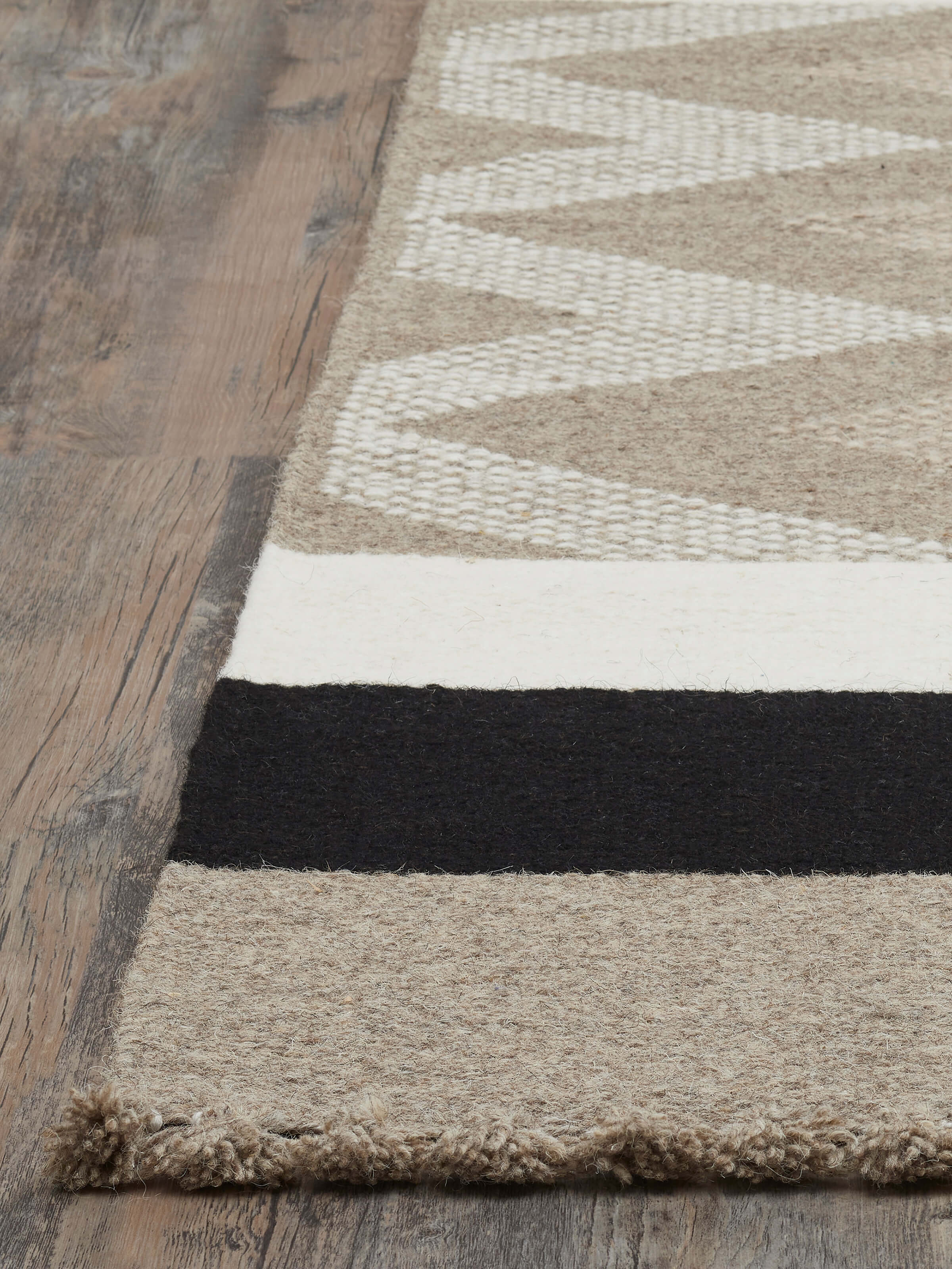 Angled view of Textured Chevron Grey Melange Jawaja wool & cotton handloom dhurrie (4x6 ft), displaying its full pattern and texture.