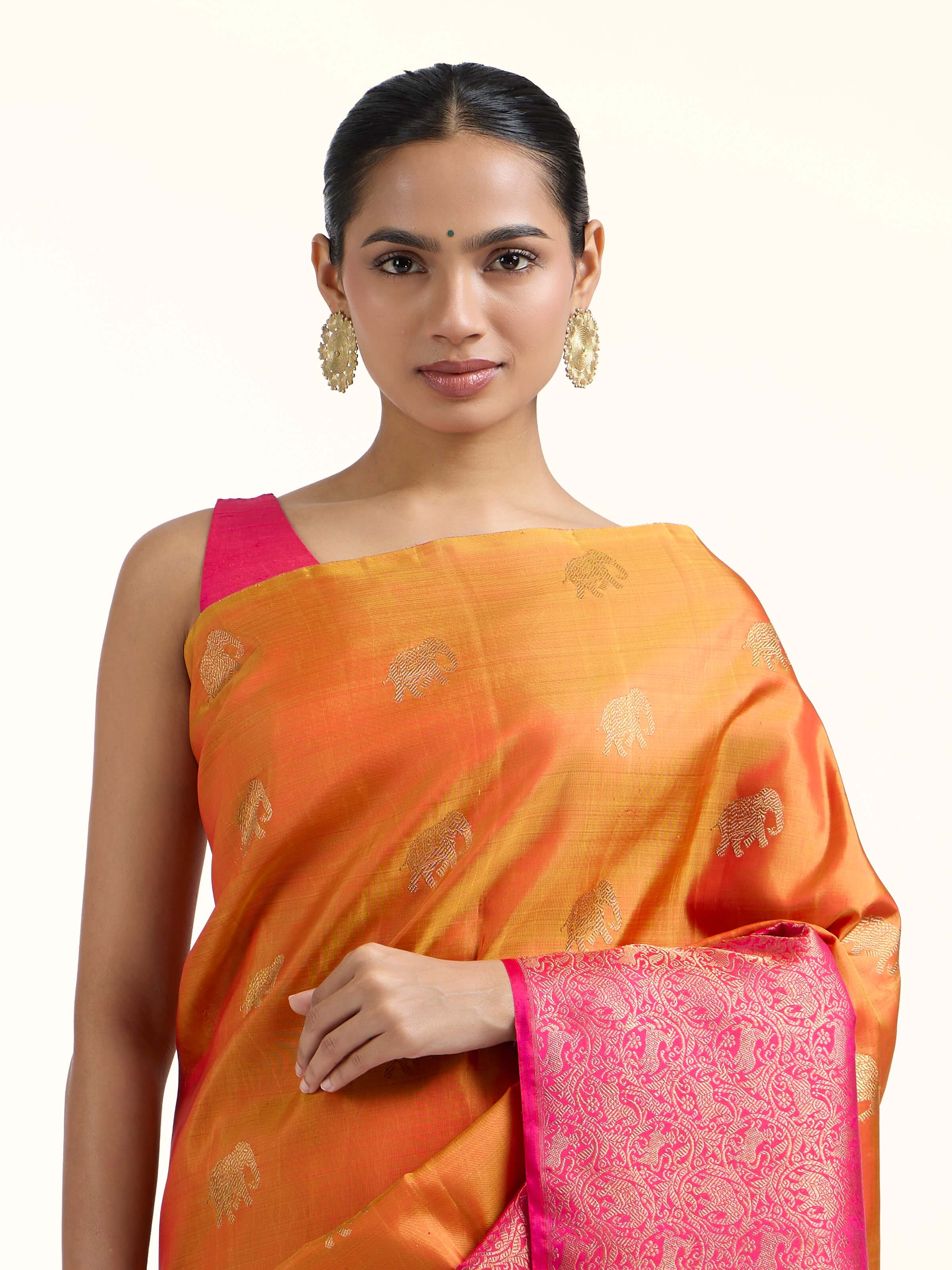 Angled view of orange silk Kancheepuram saree highlighting woven motifs