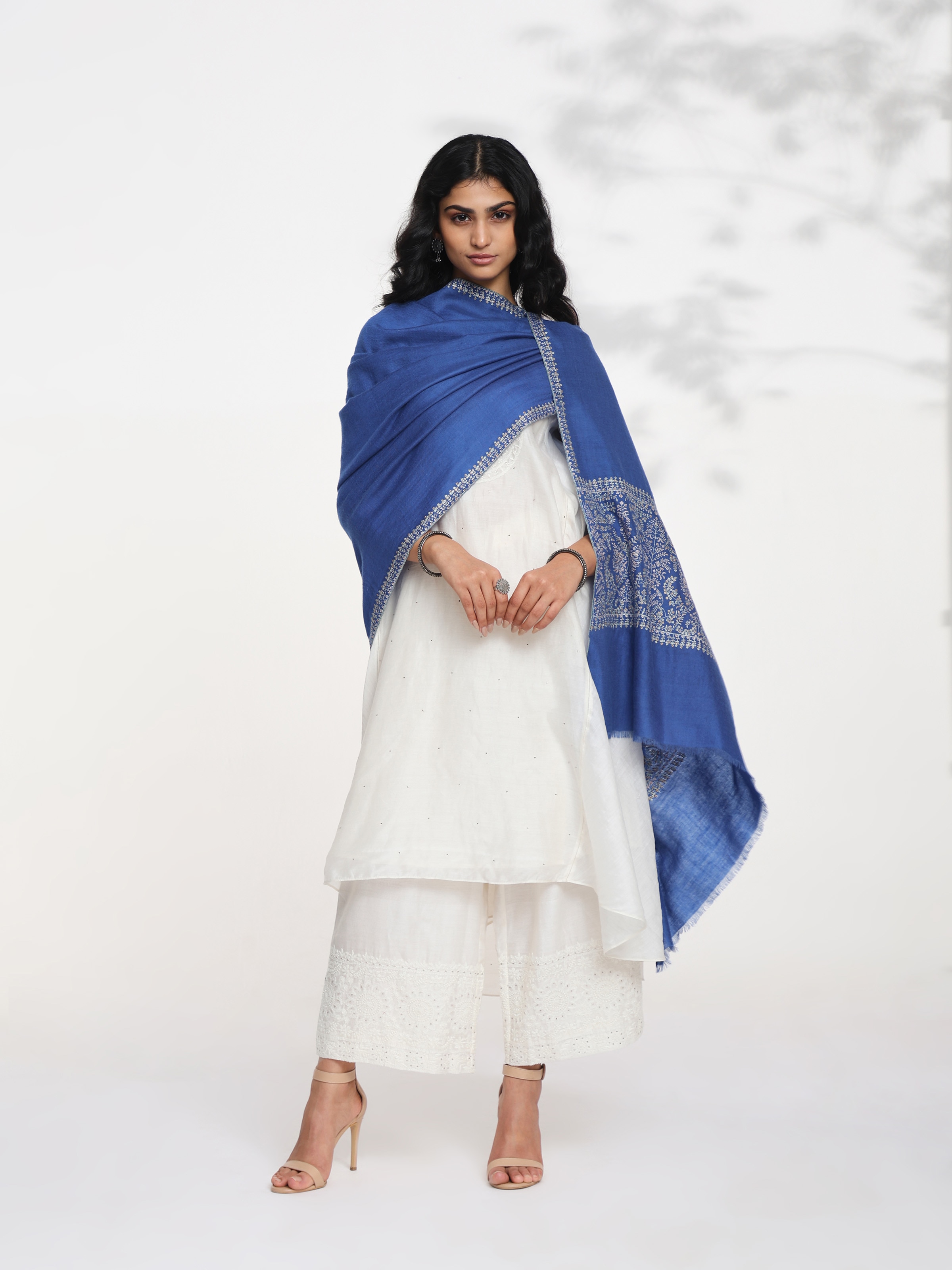 Side view of blue Palledar Sozni embroidered shawl showcasing drape and flow